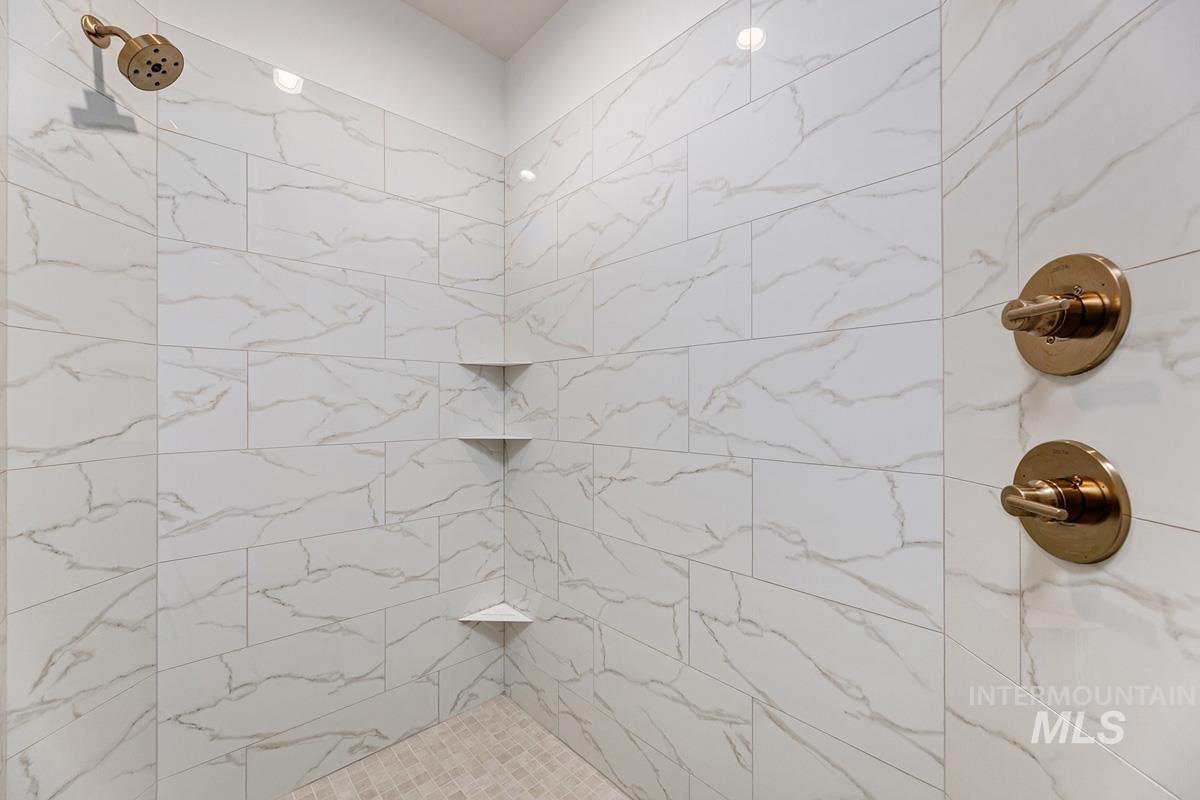 Bathroom with a marble finish shower