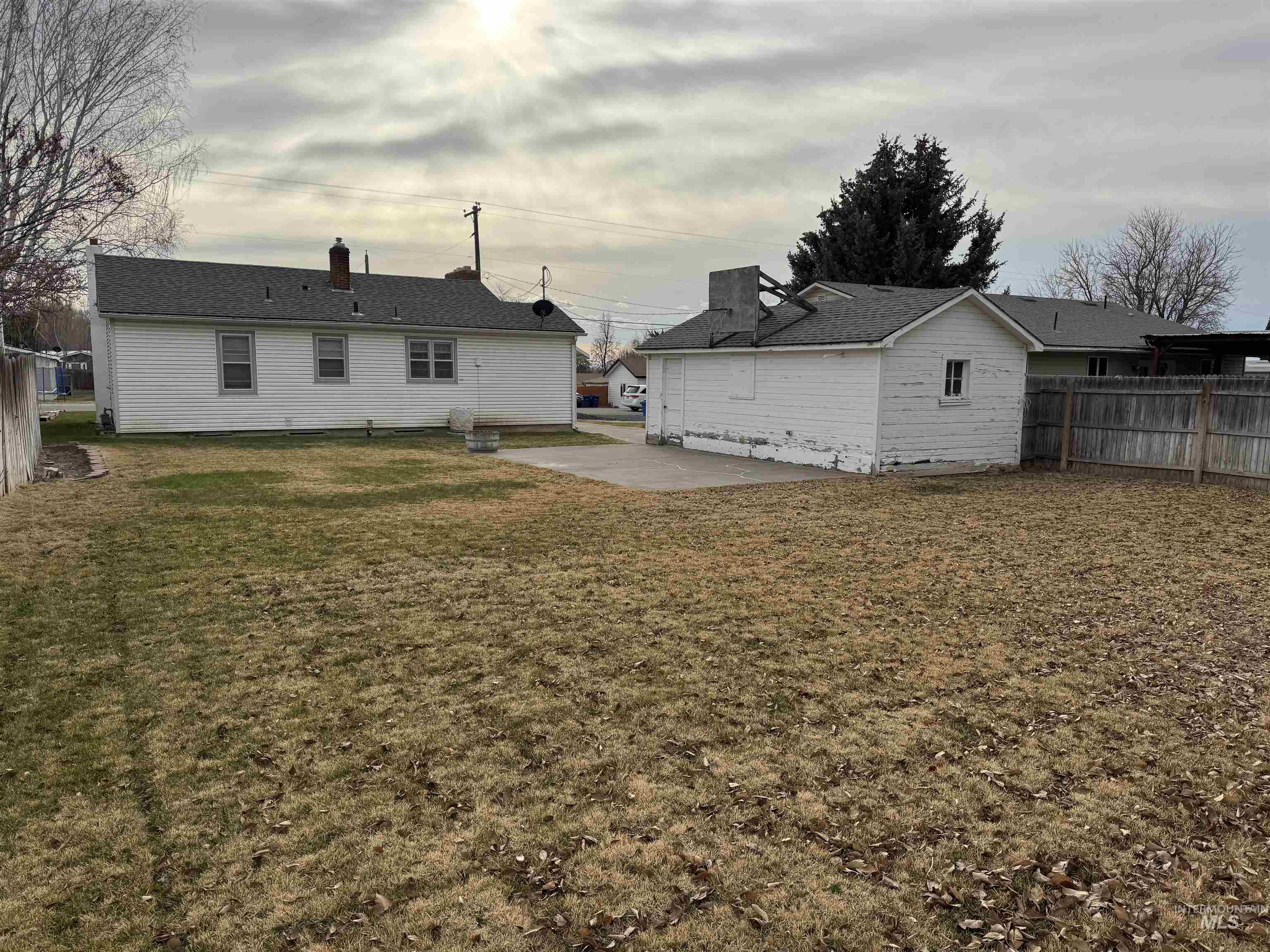 Rear view of house featuring a patio area and a chimney