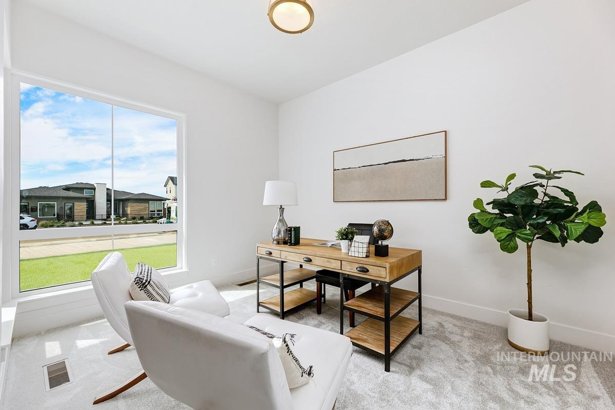 Home office featuring light colored carpet and baseboards