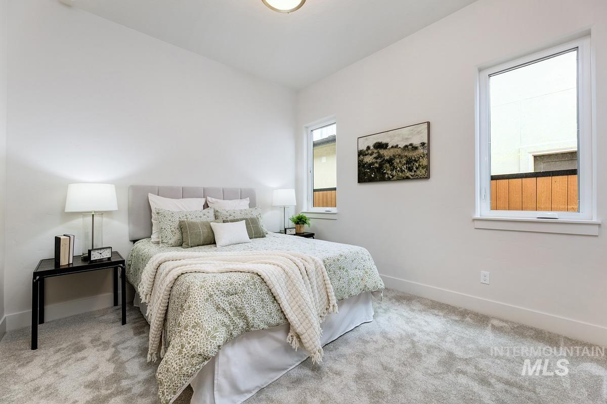 Bedroom with light colored carpet