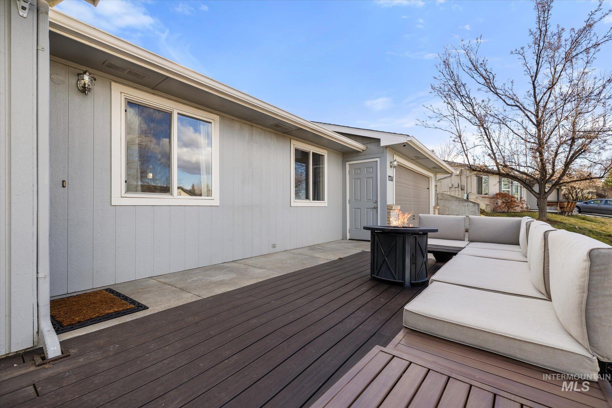 Deck featuring an outdoor living space with a fire pit and a patio area