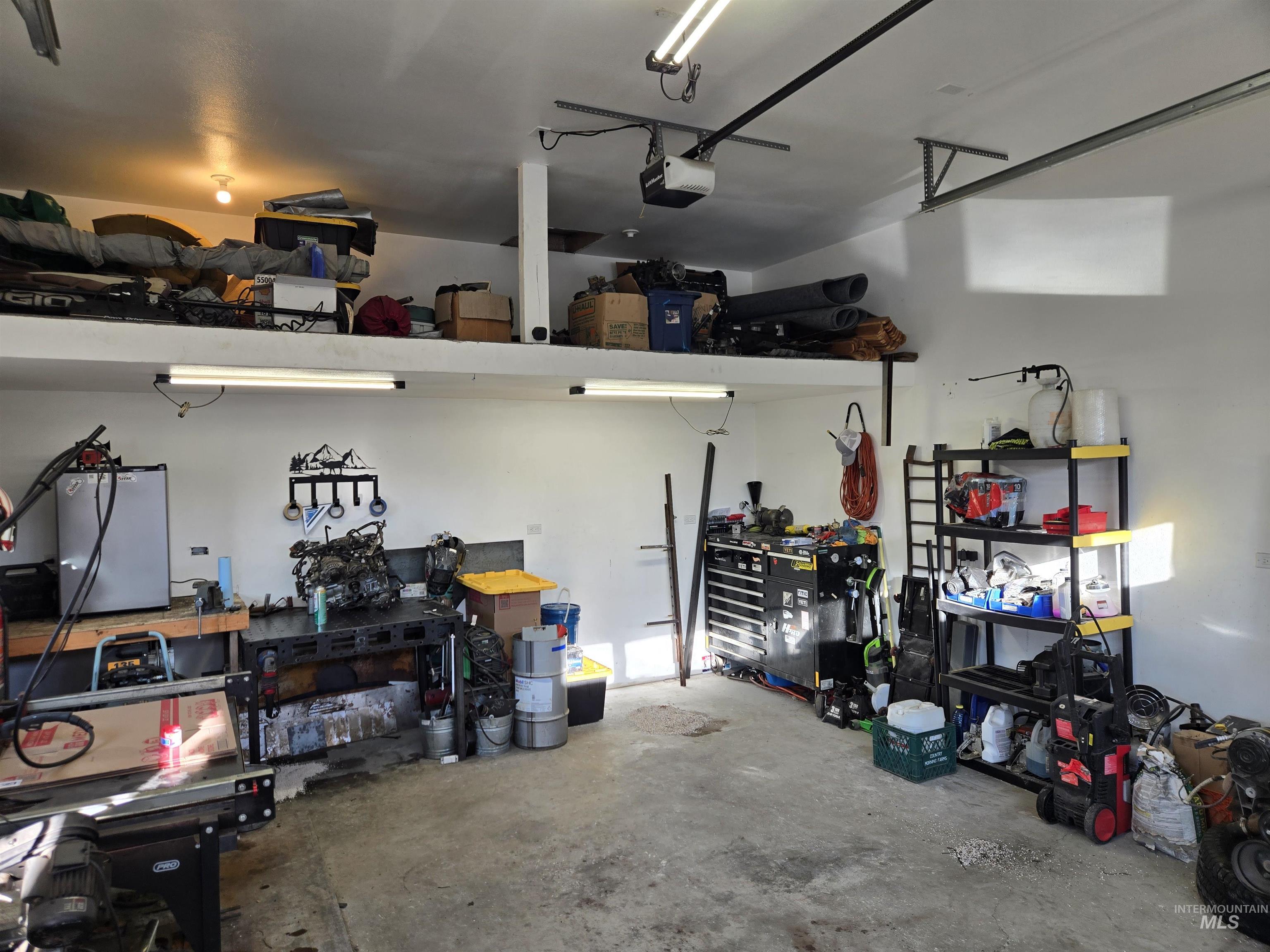 Garage with a workshop area and a garage door opener
