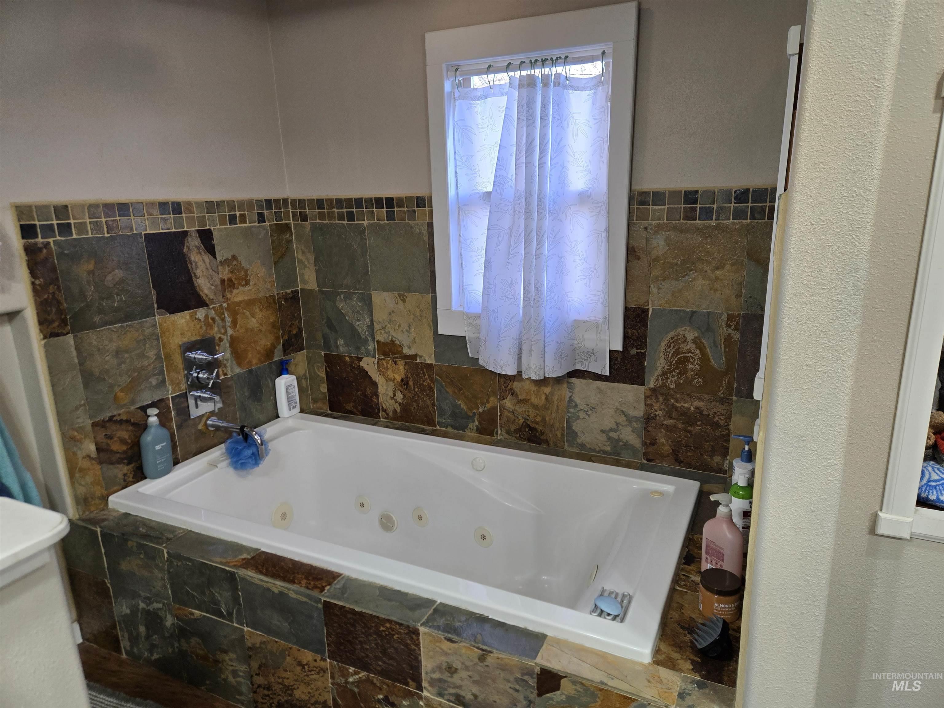 Full bath with a jetted tub