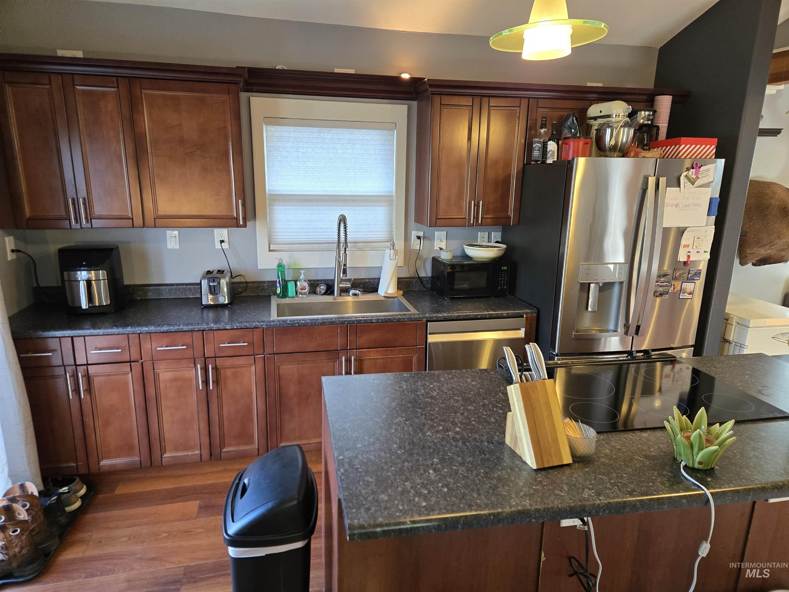 Kitchen featuring stainless steel appliances and dark wood finished floors