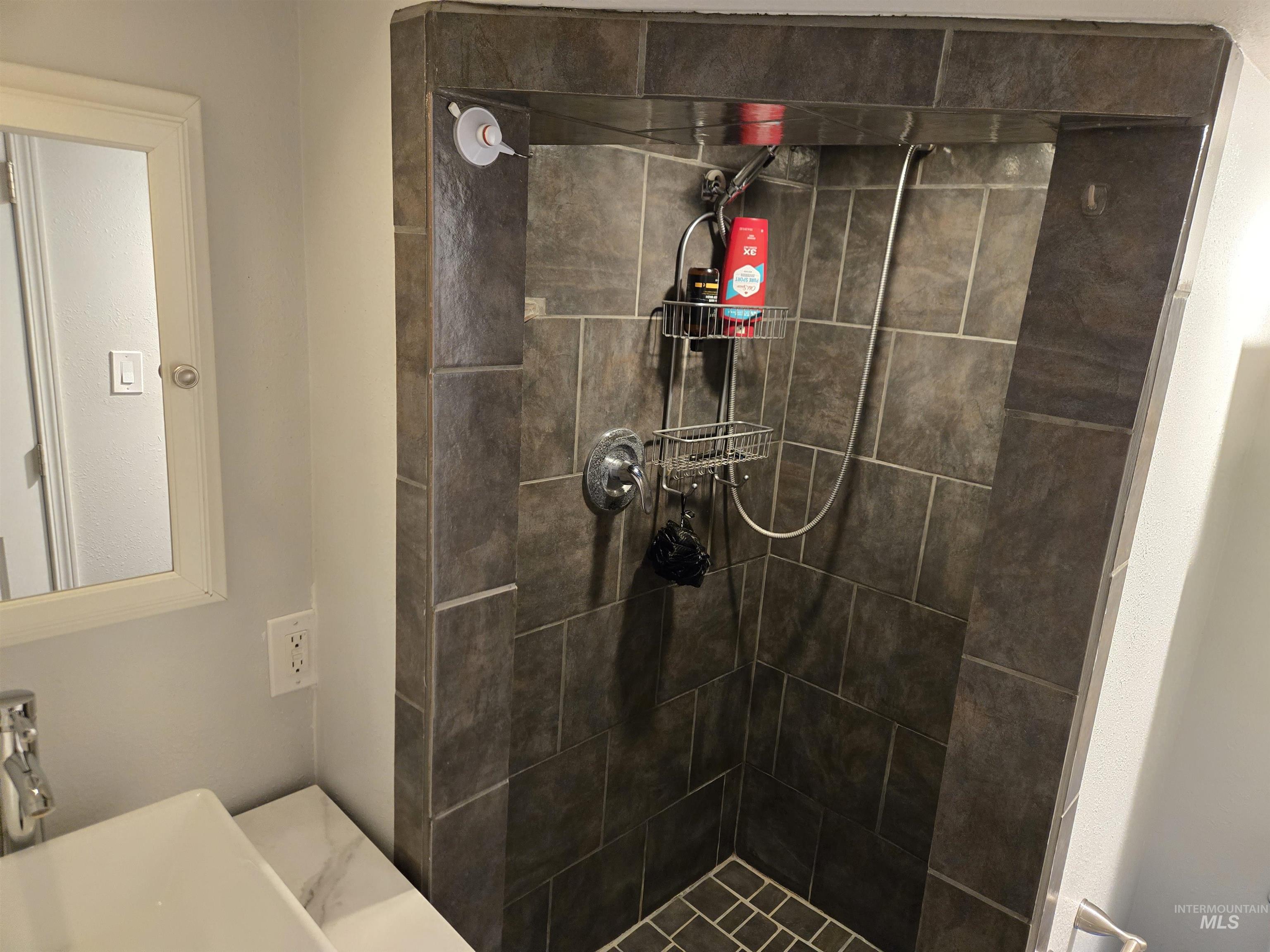 Bathroom with a stall shower and vanity