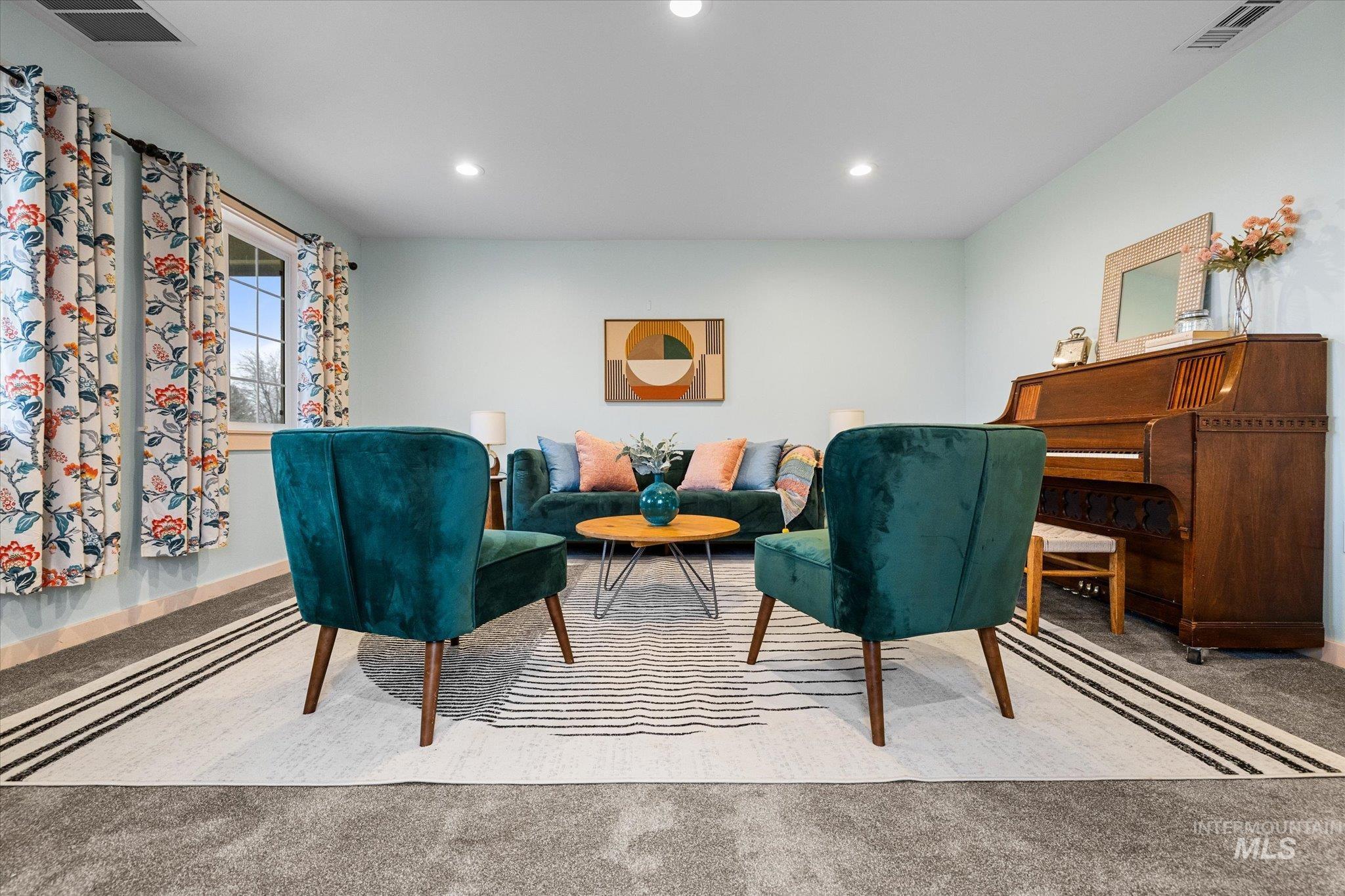 Living area with carpet flooring and recessed lighting