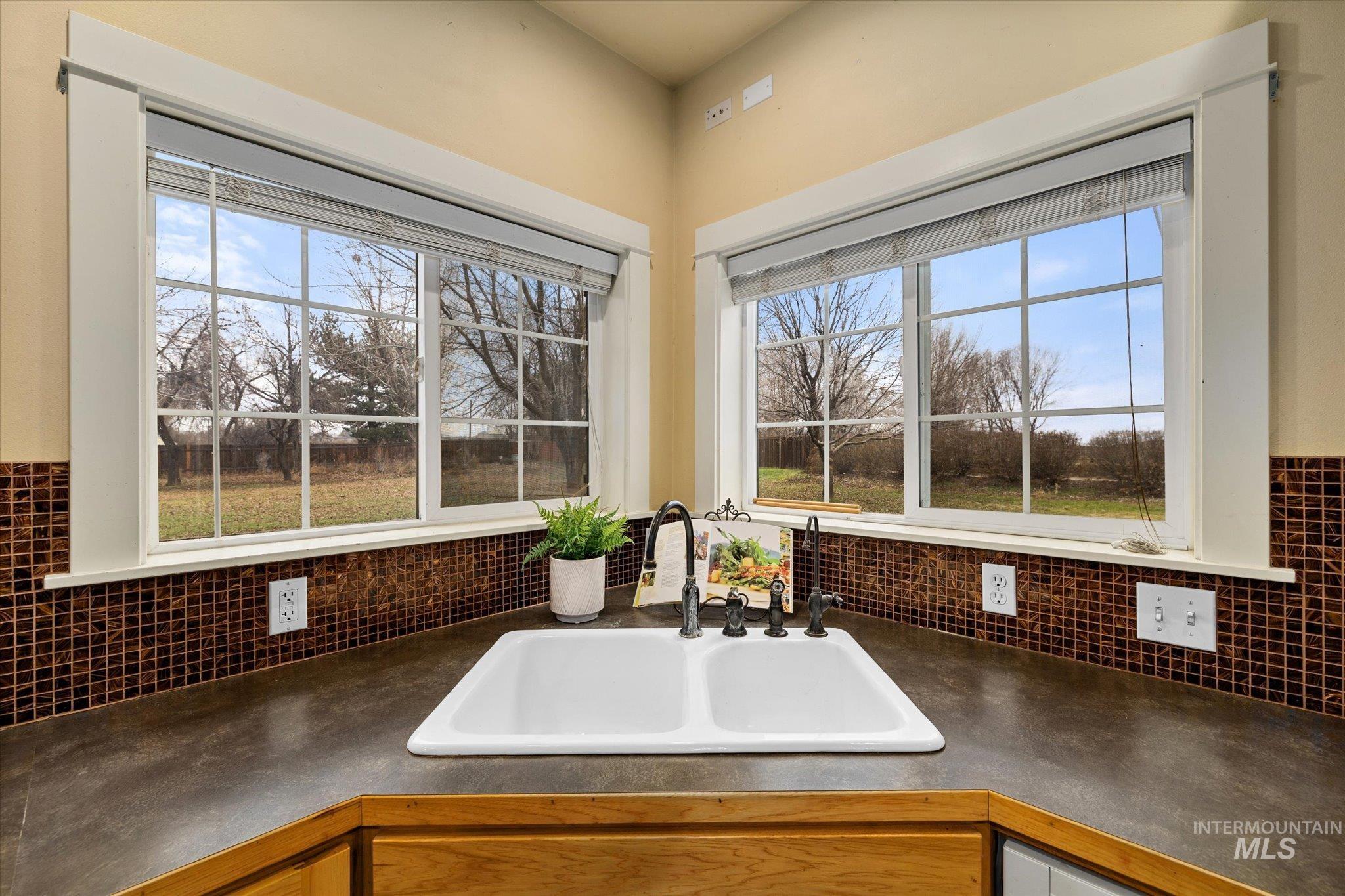 Kitchen featuring dark countertops and healthy amount of natural light