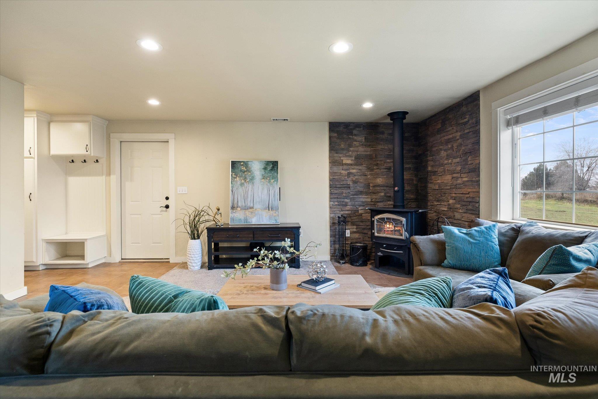 Living room featuring a wood stove and recessed lighting