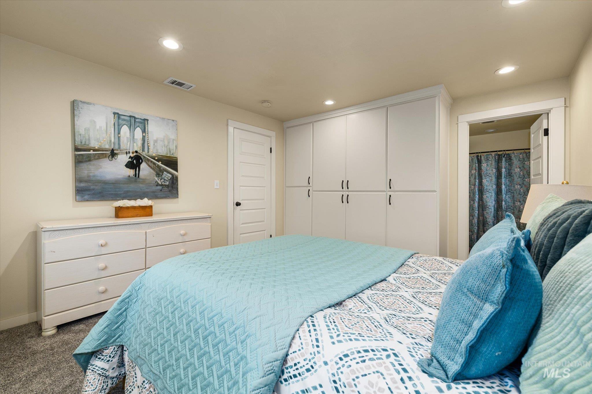 Carpeted bedroom featuring recessed lighting and a closet