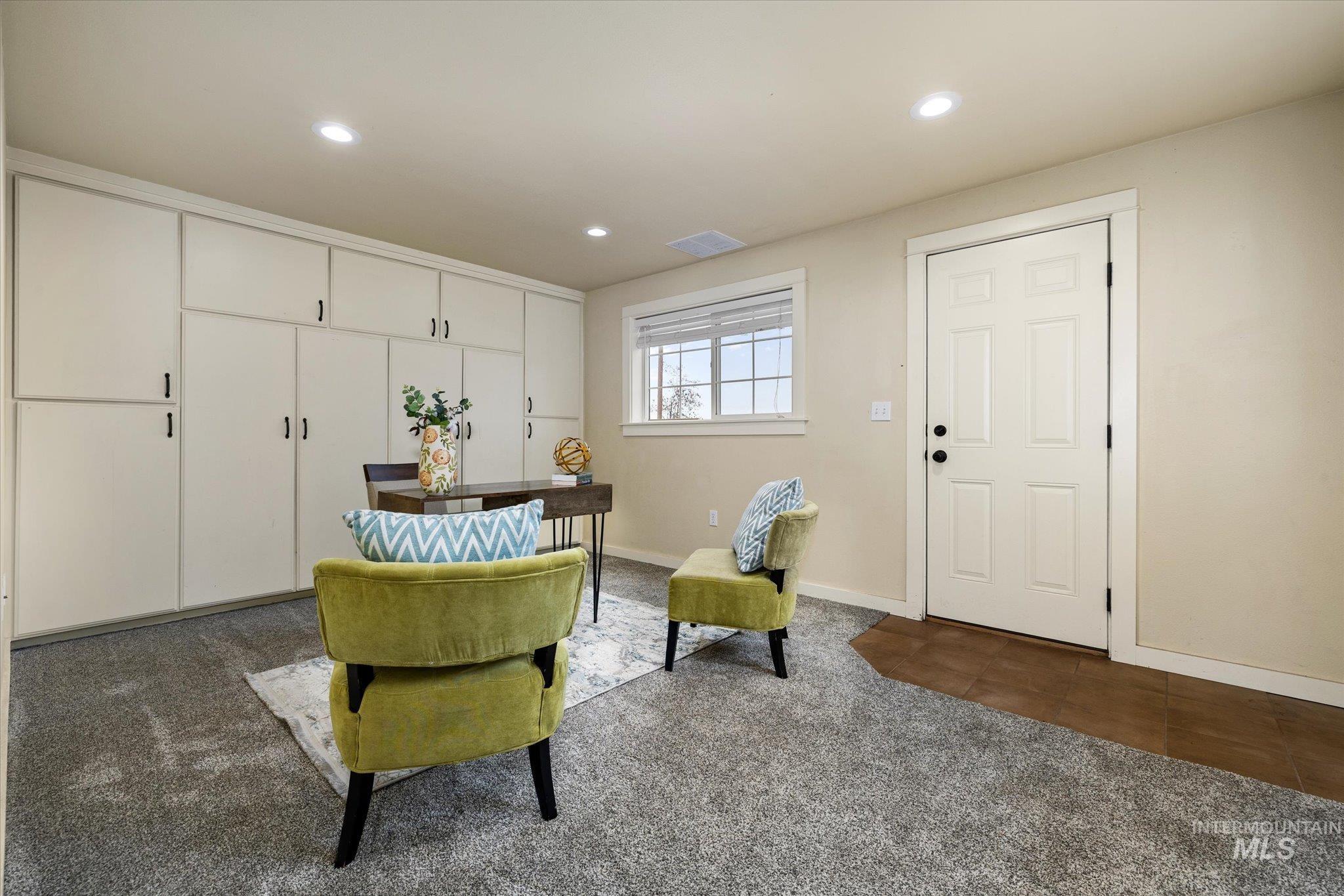 Sitting room with dark carpet, recessed lighting, and dark tile patterned flooring