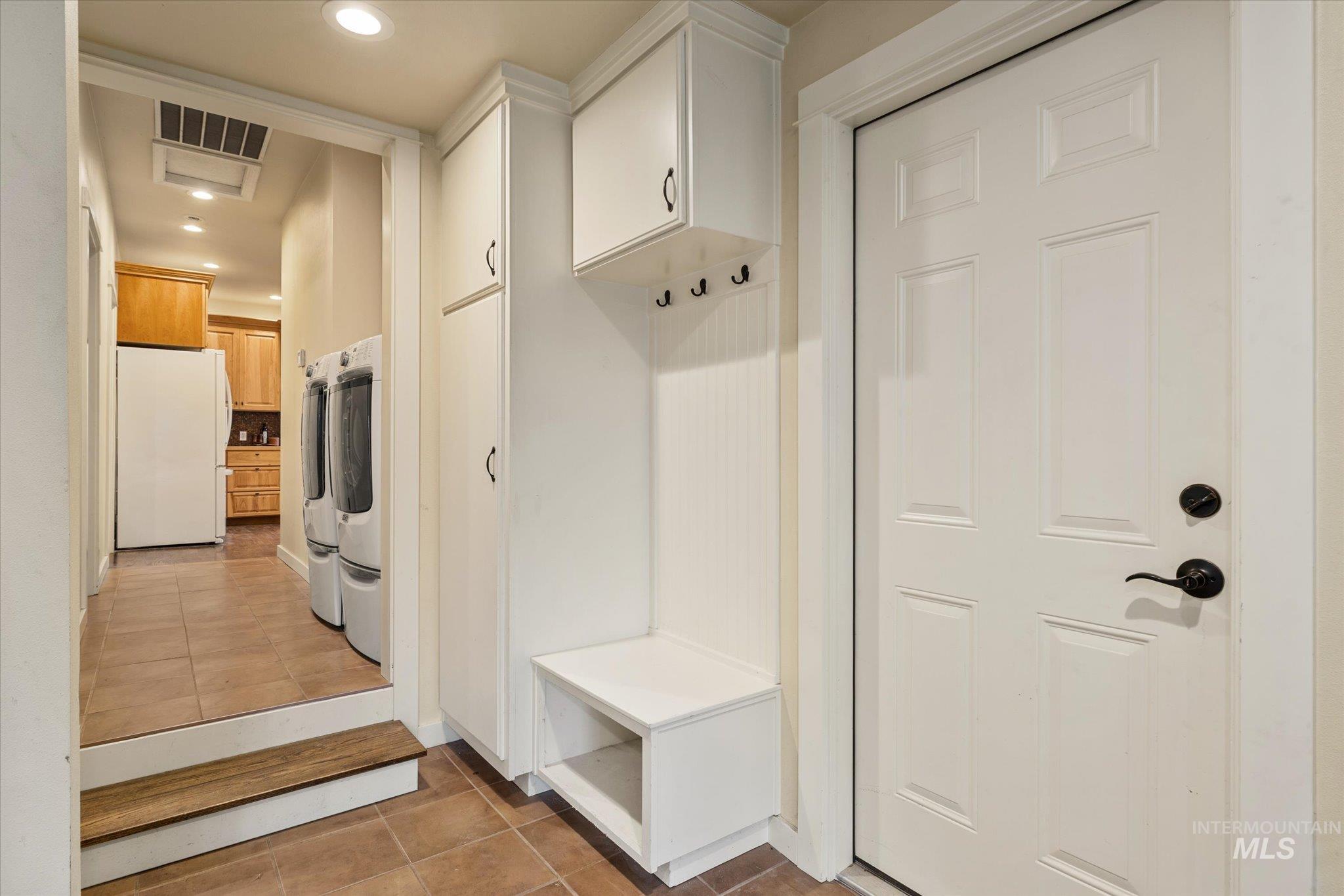 Mudroom with light tile patterned floors, recessed lighting, and washer and clothes dryer