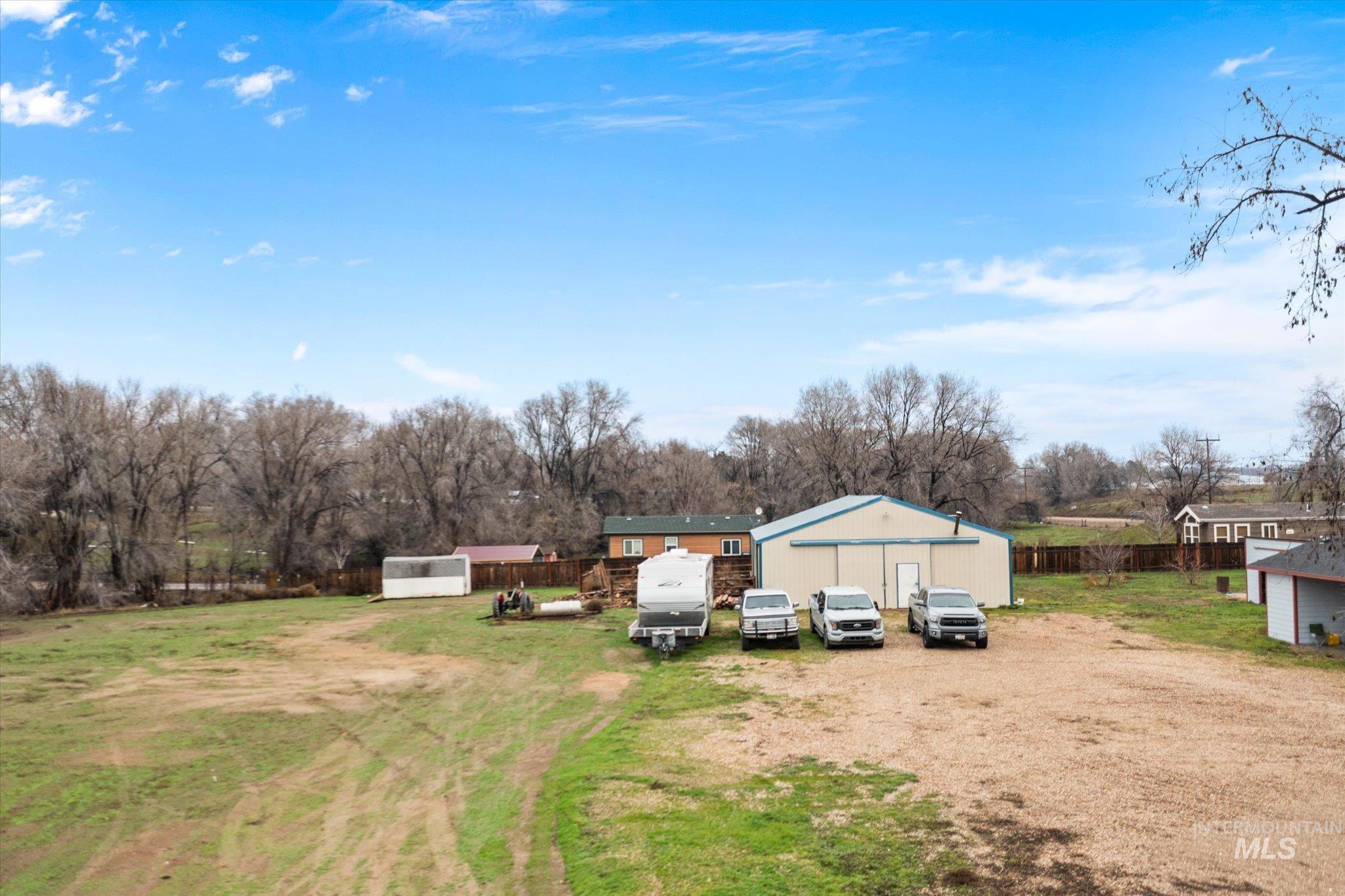 View of yard with an outbuilding and view of wooded area