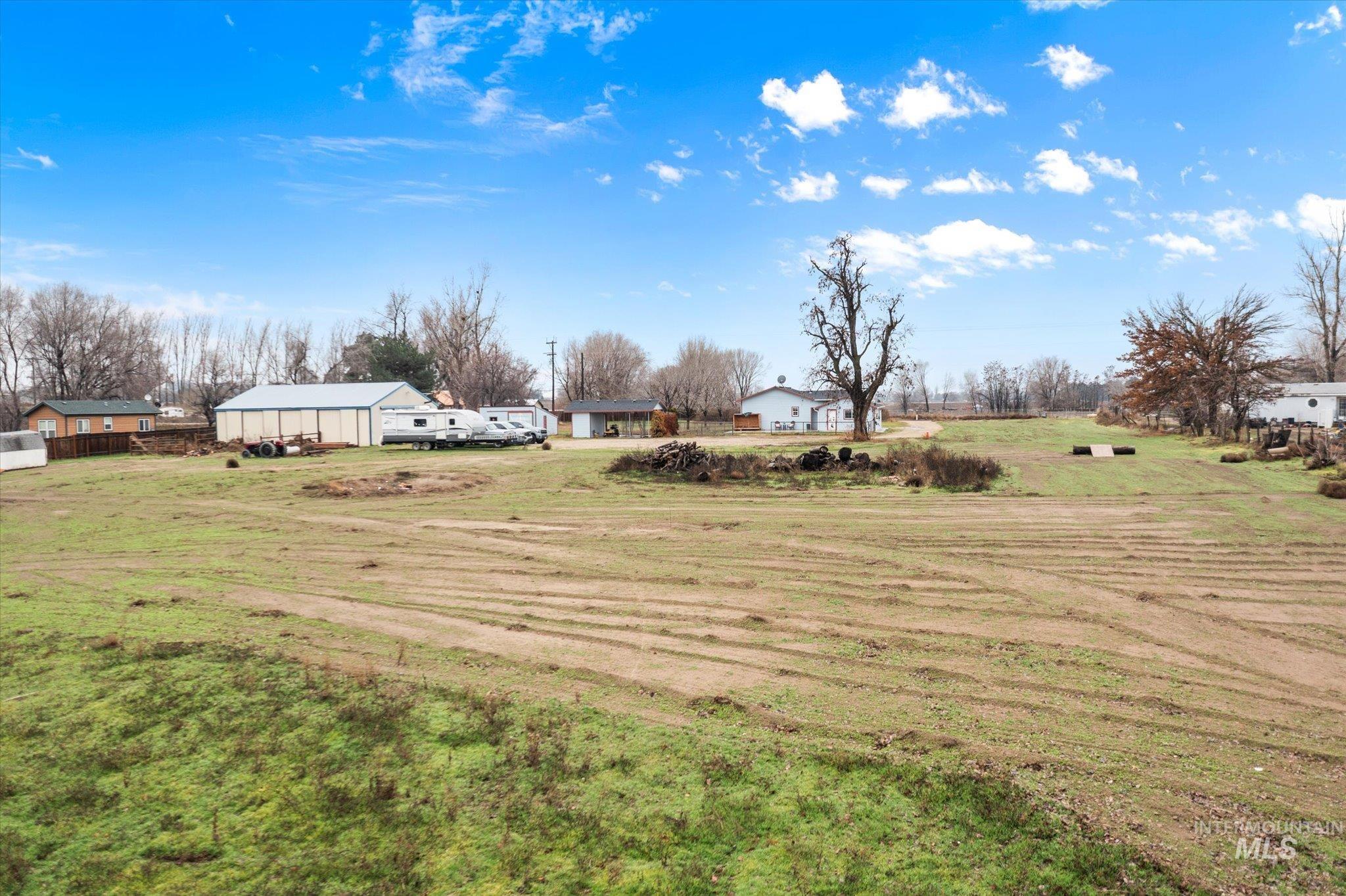 View of green lawn with a view of rural / pastoral area and an outdoor structure