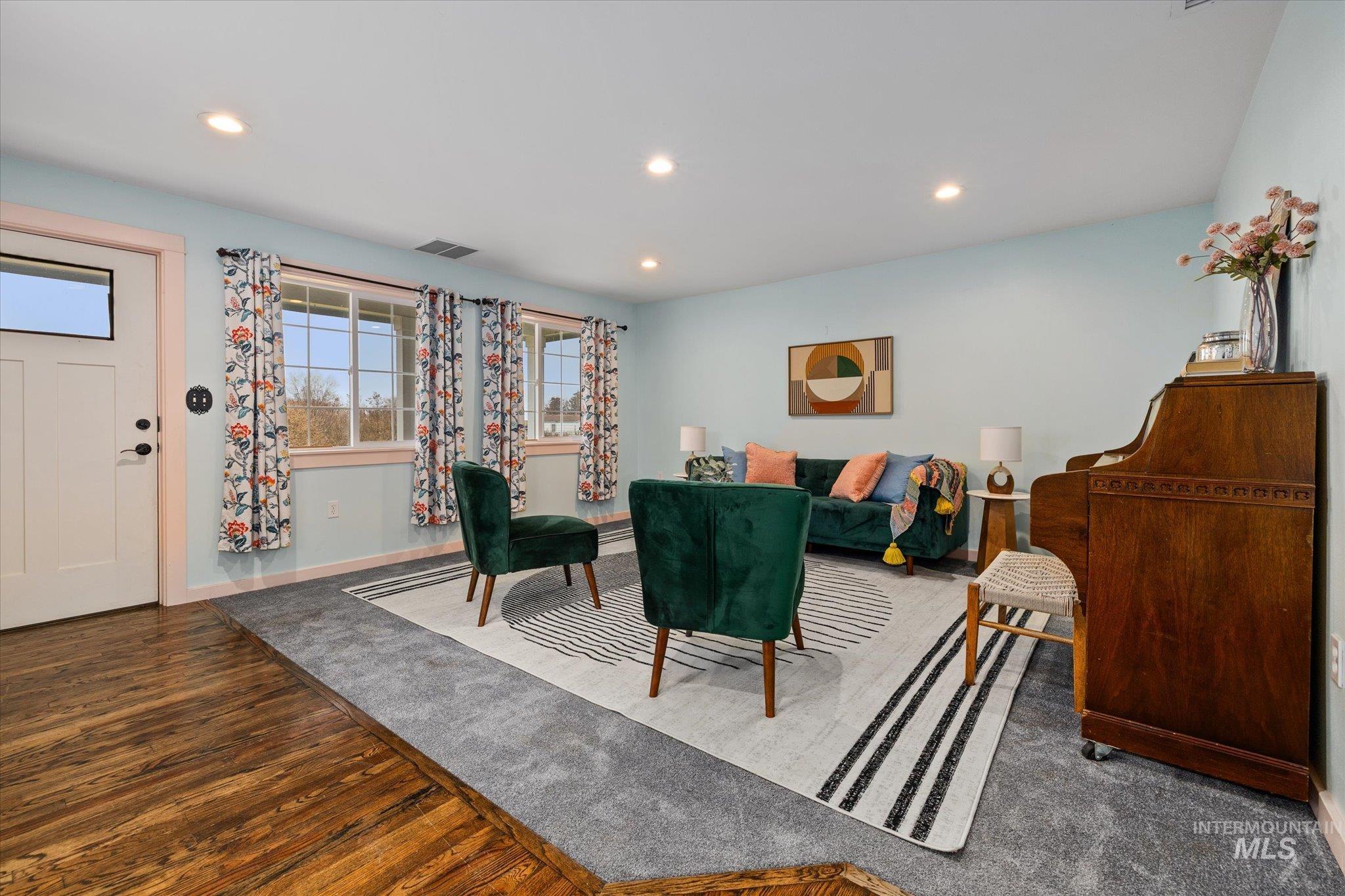 Living room with recessed lighting and wood finished floors