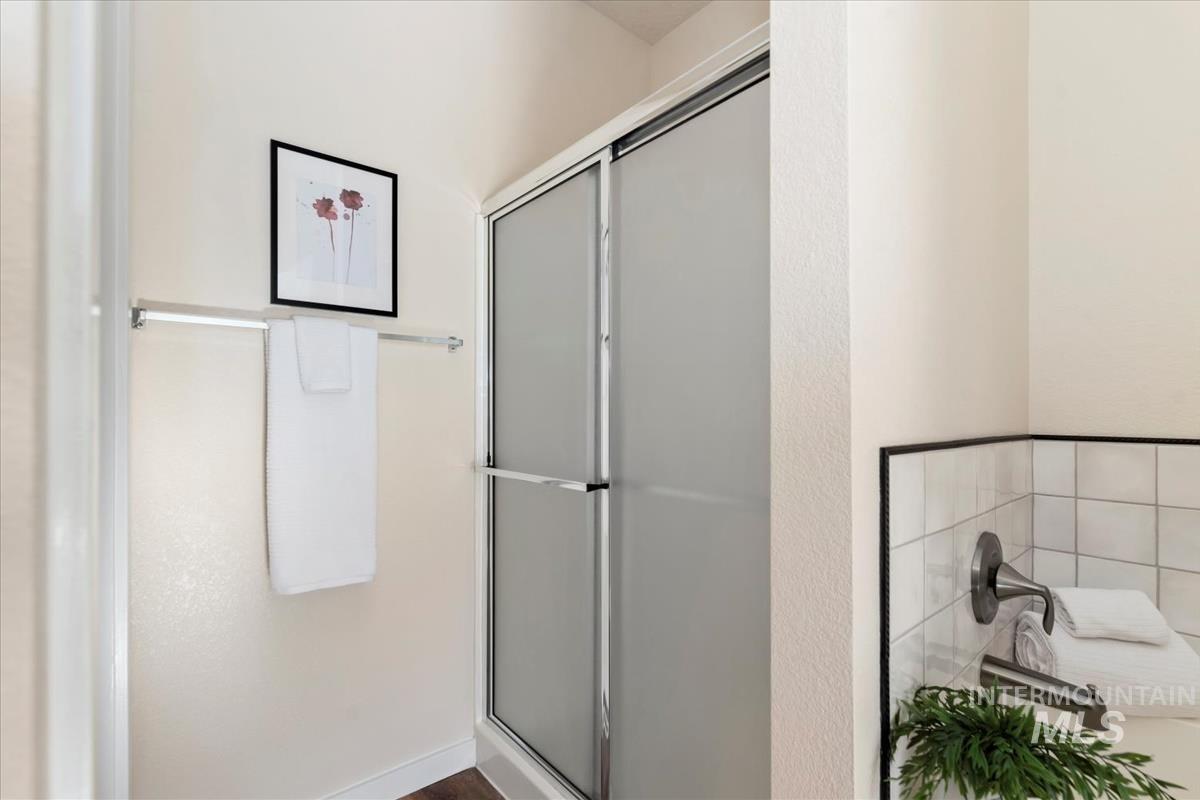 Full bath featuring a shower stall and a garden tub