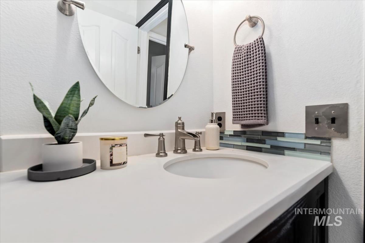 Bathroom with vanity and a textured wall
