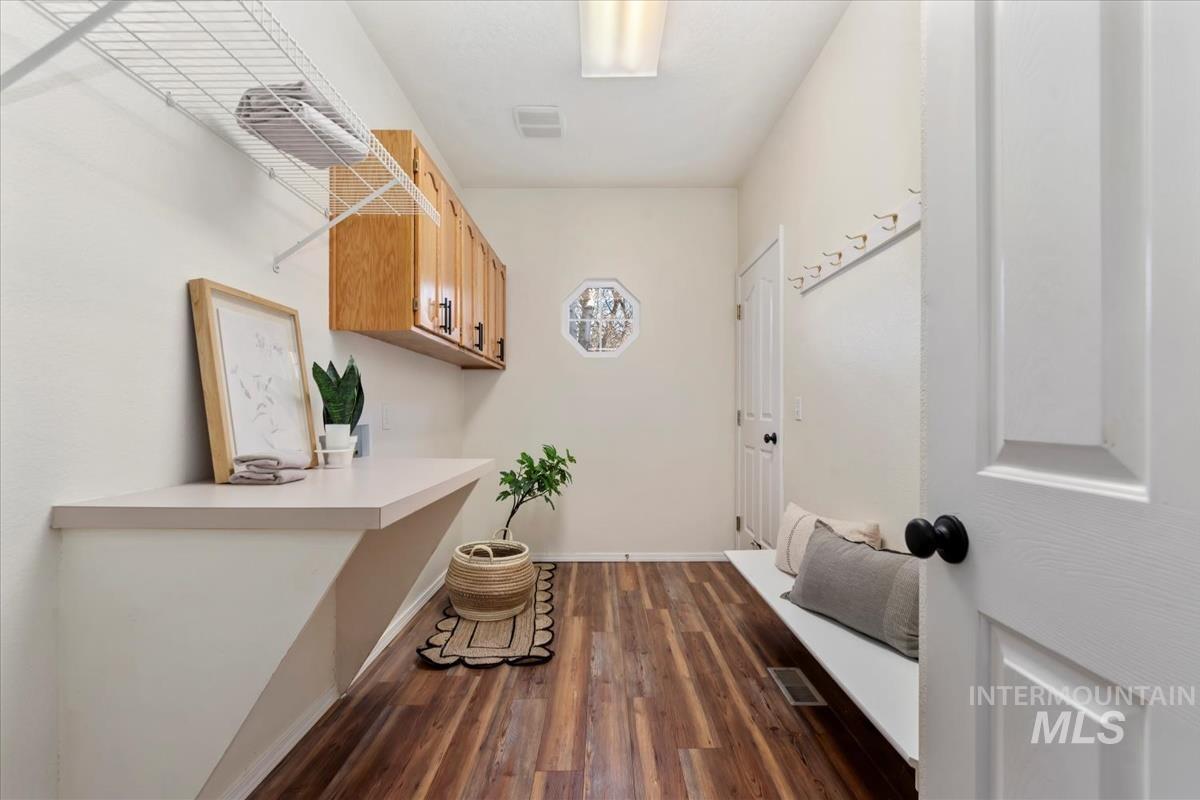 Interior space featuring dark wood-style floors and baseboards