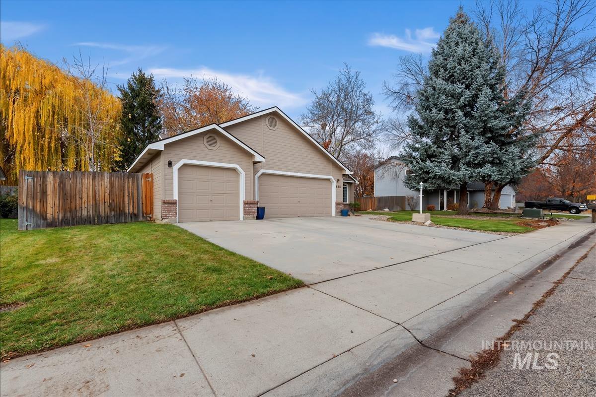 View of front of property featuring concrete driveway and brick siding