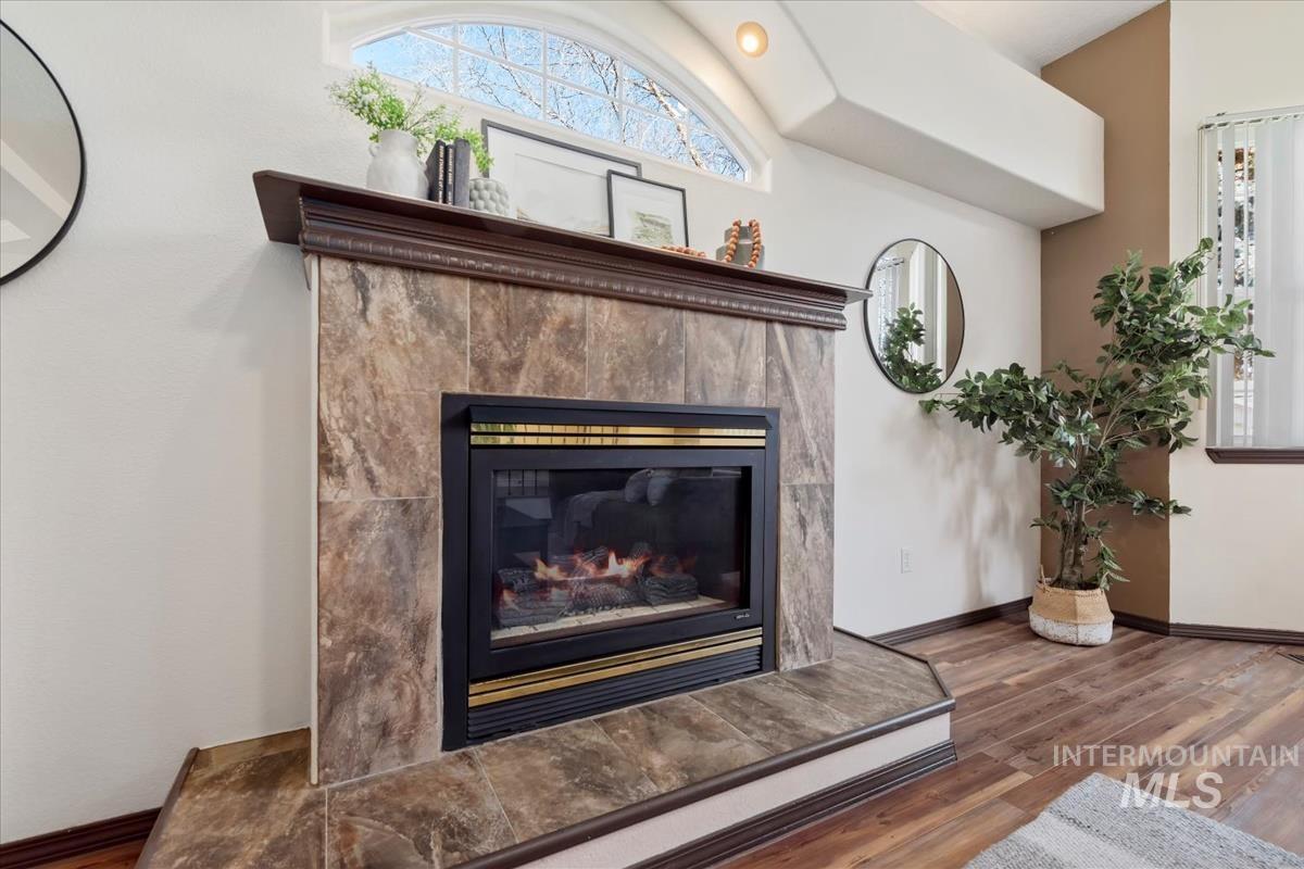 Detailed view of wood finished floors and a tiled fireplace