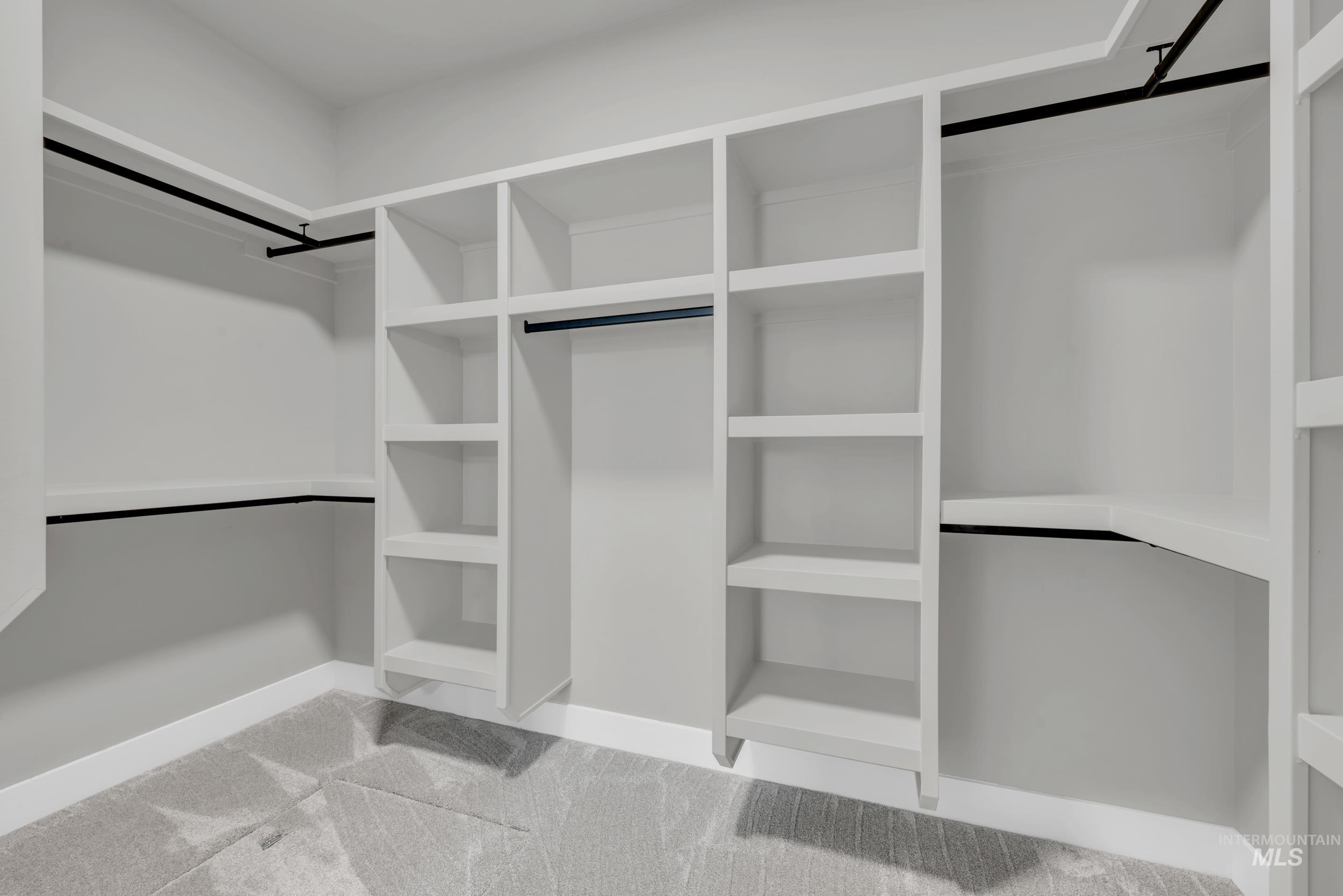 Spacious closet with light colored carpet