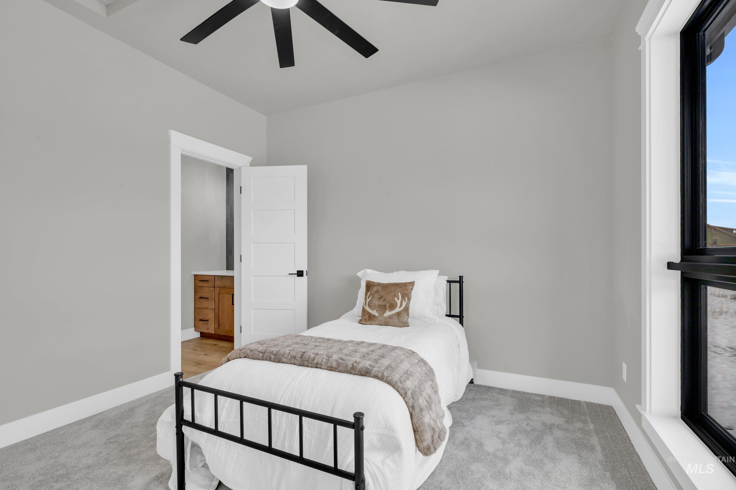 Bedroom featuring ceiling fan and light carpet