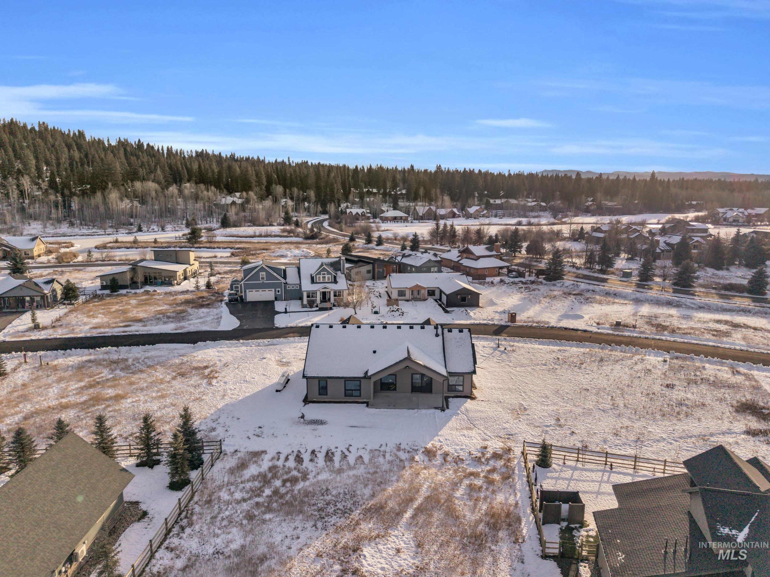 Snowy aerial view with a forest view