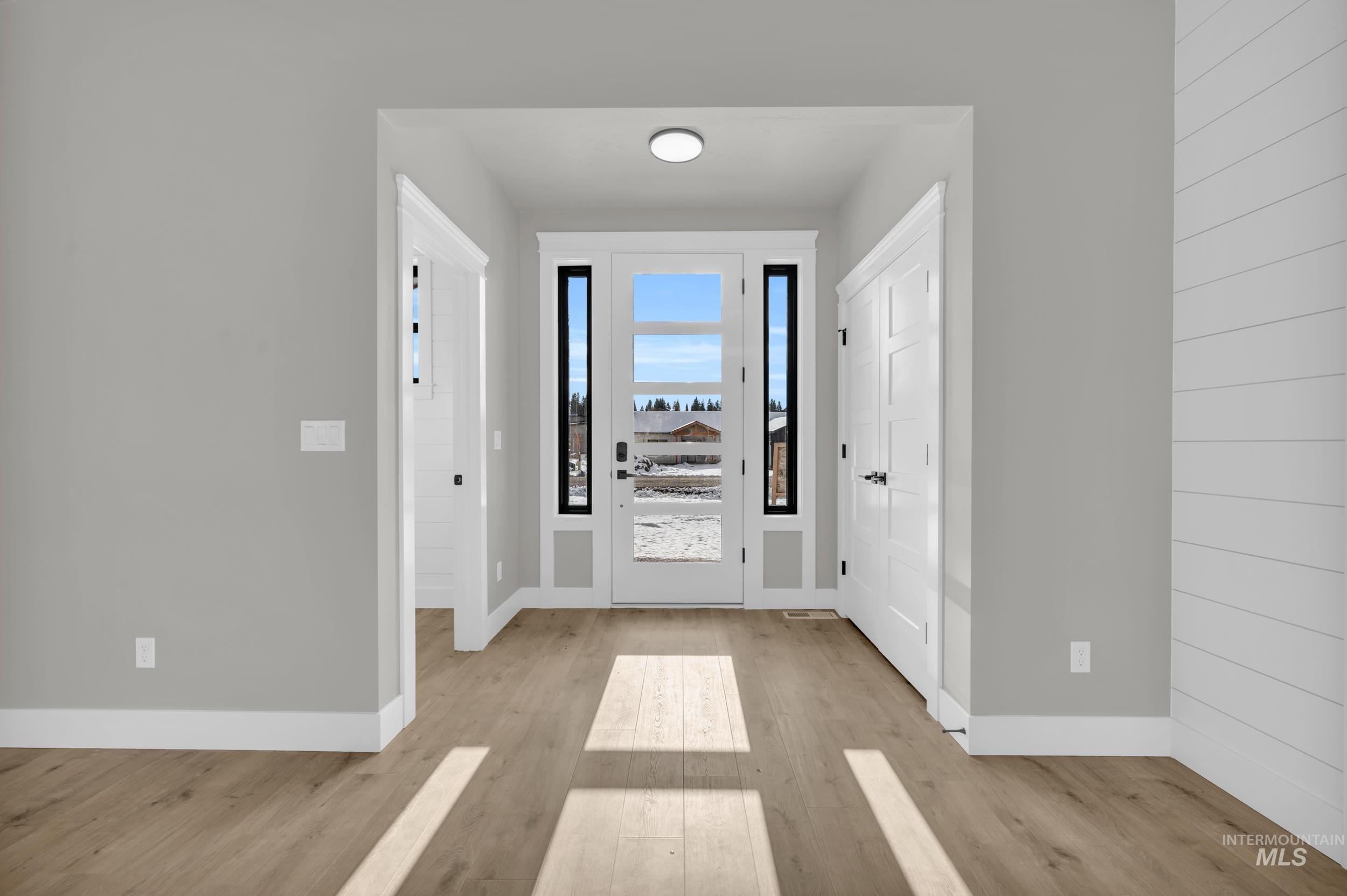 Entrance foyer with light wood-style floors