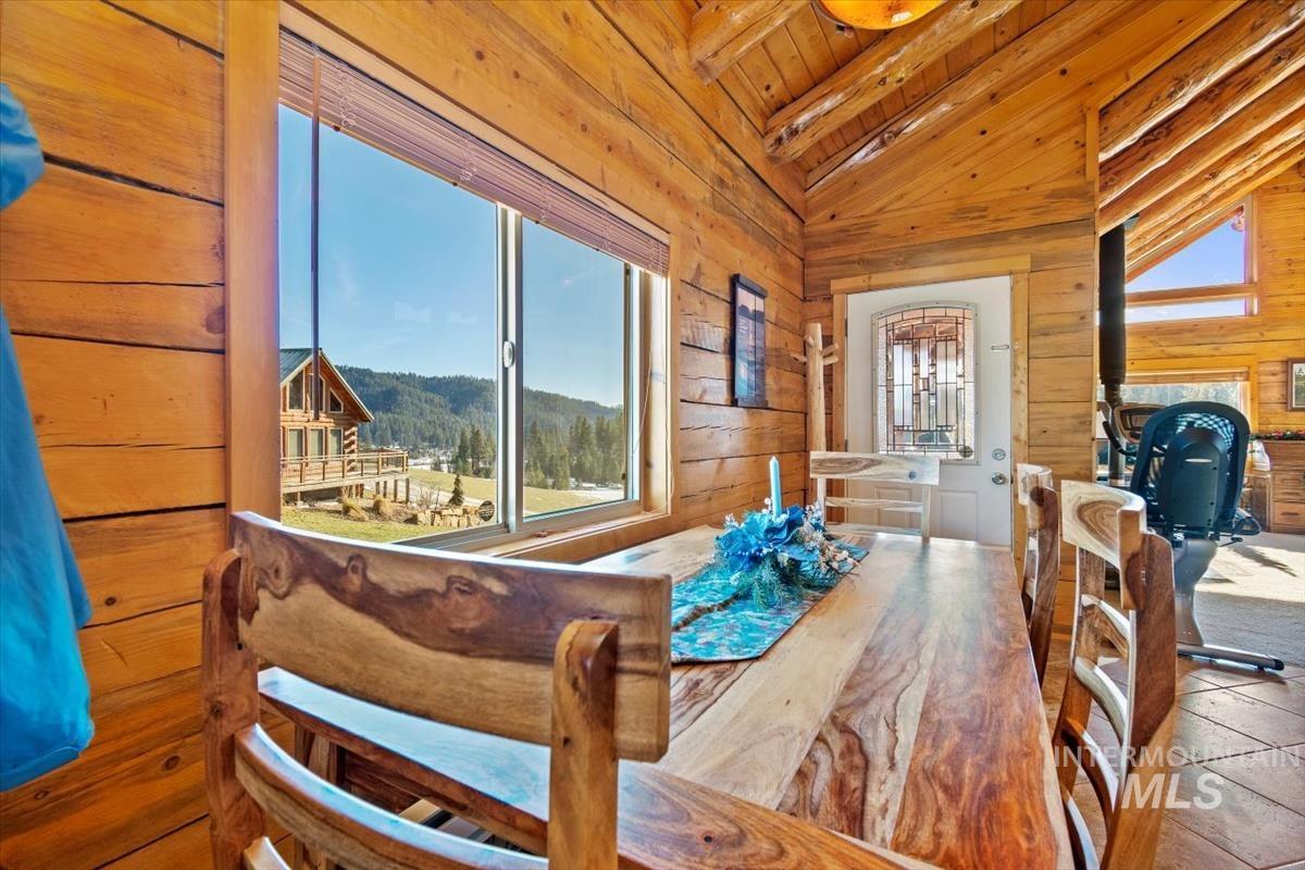 Dining room featuring wooden walls and wooden ceiling