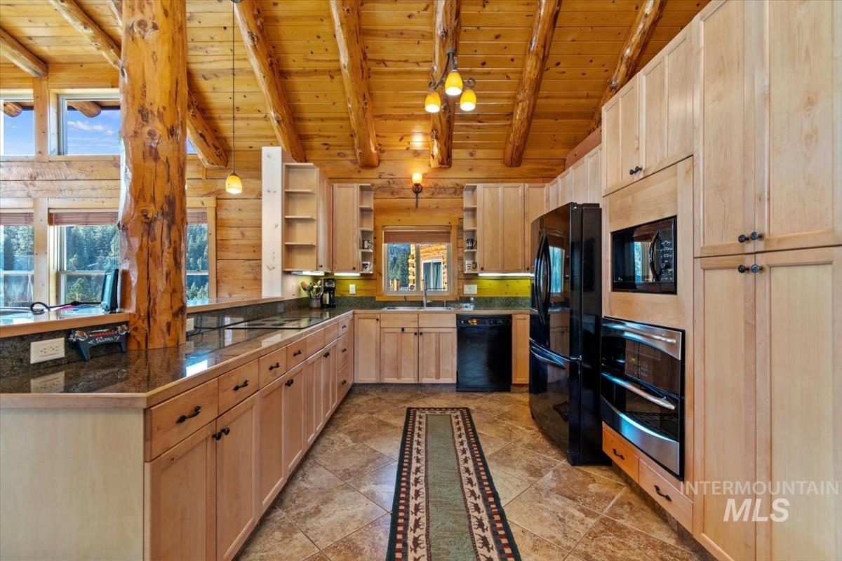 Kitchen featuring open shelves, wooden ceiling, light brown cabinetry, black appliances, and decorative light fixtures
