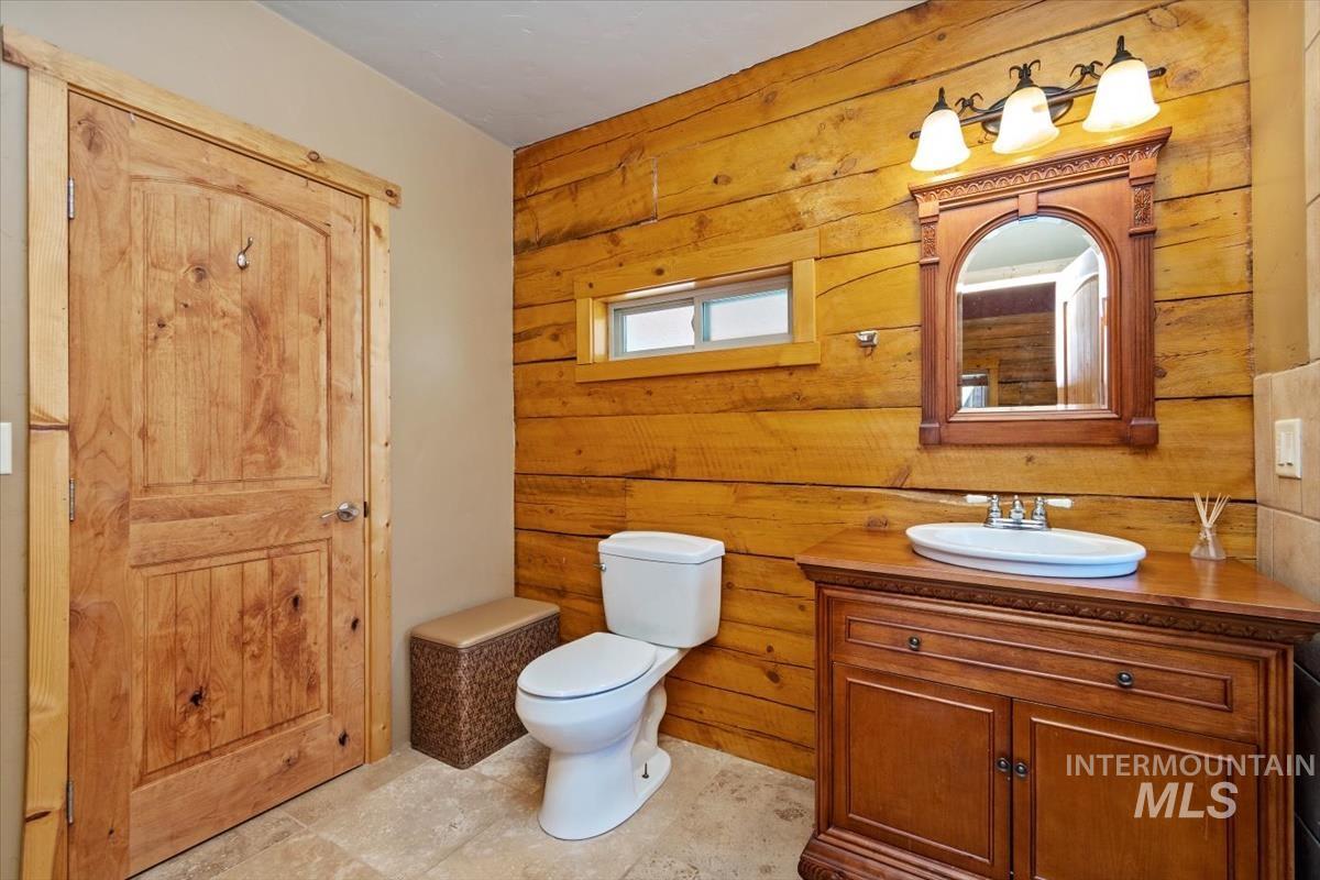 Bathroom with wood walls and vanity