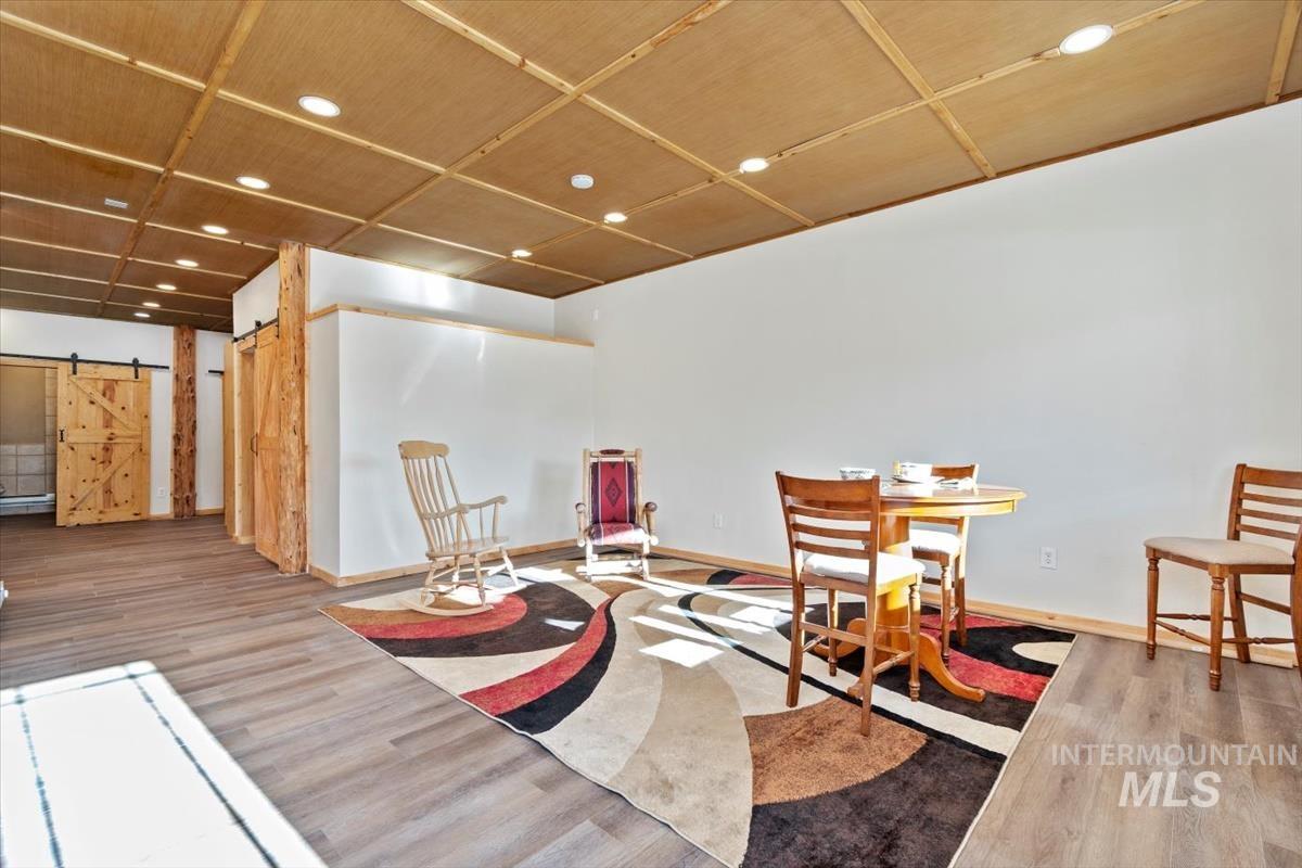 Living area with a barn door and recessed lighting