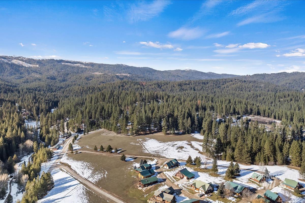 View of property location featuring mountains and a heavily wooded area