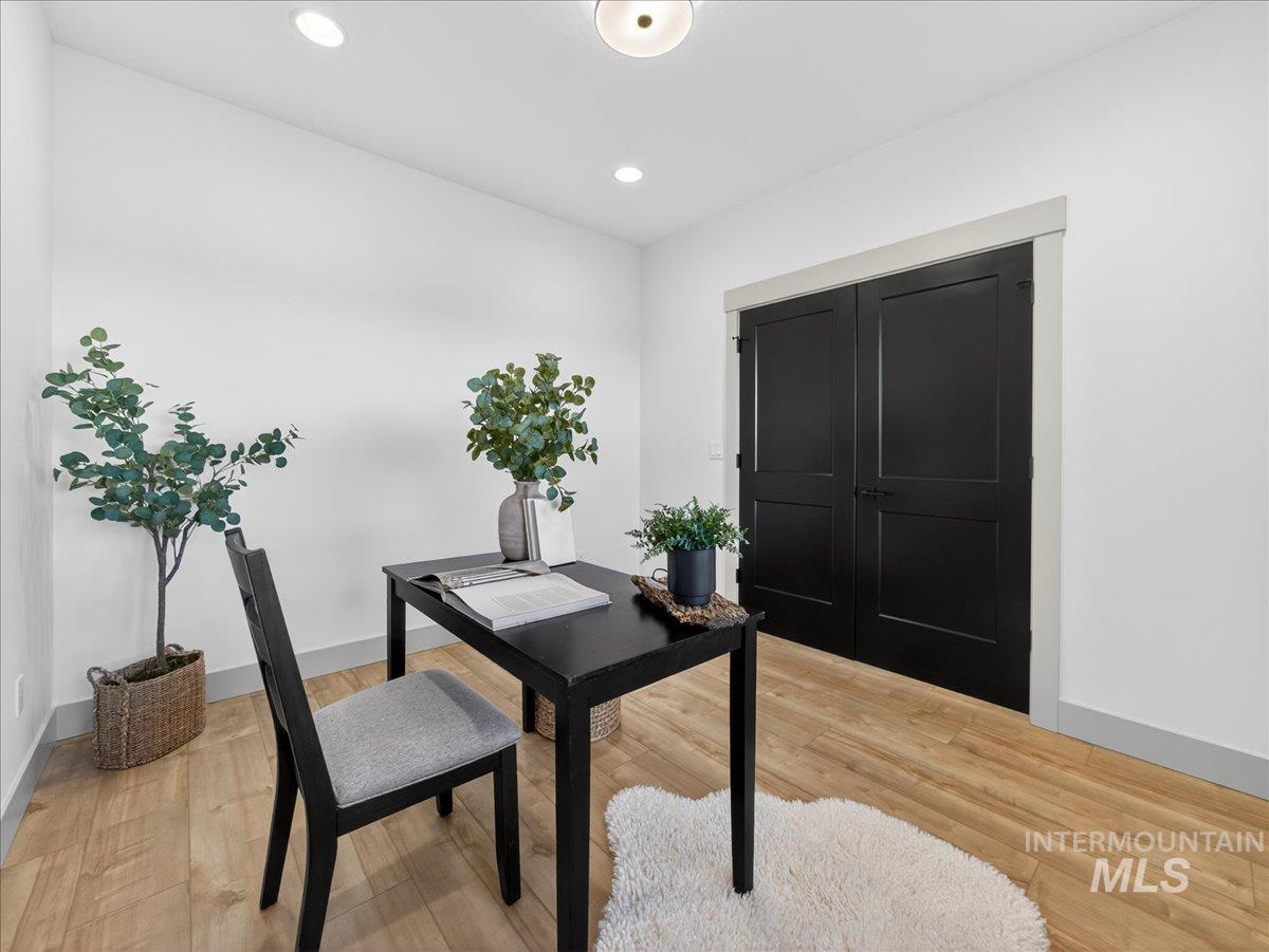 Home office featuring light wood finished floors and recessed lighting