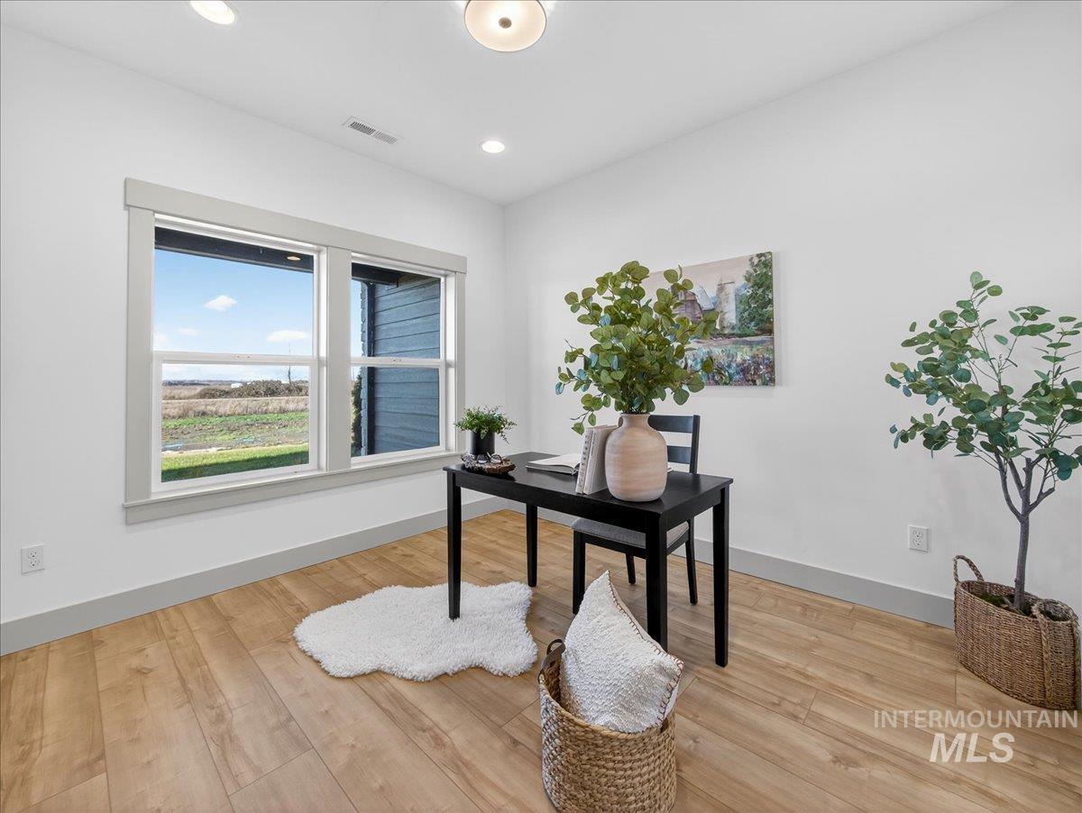 Office area featuring light wood-type flooring and recessed lighting