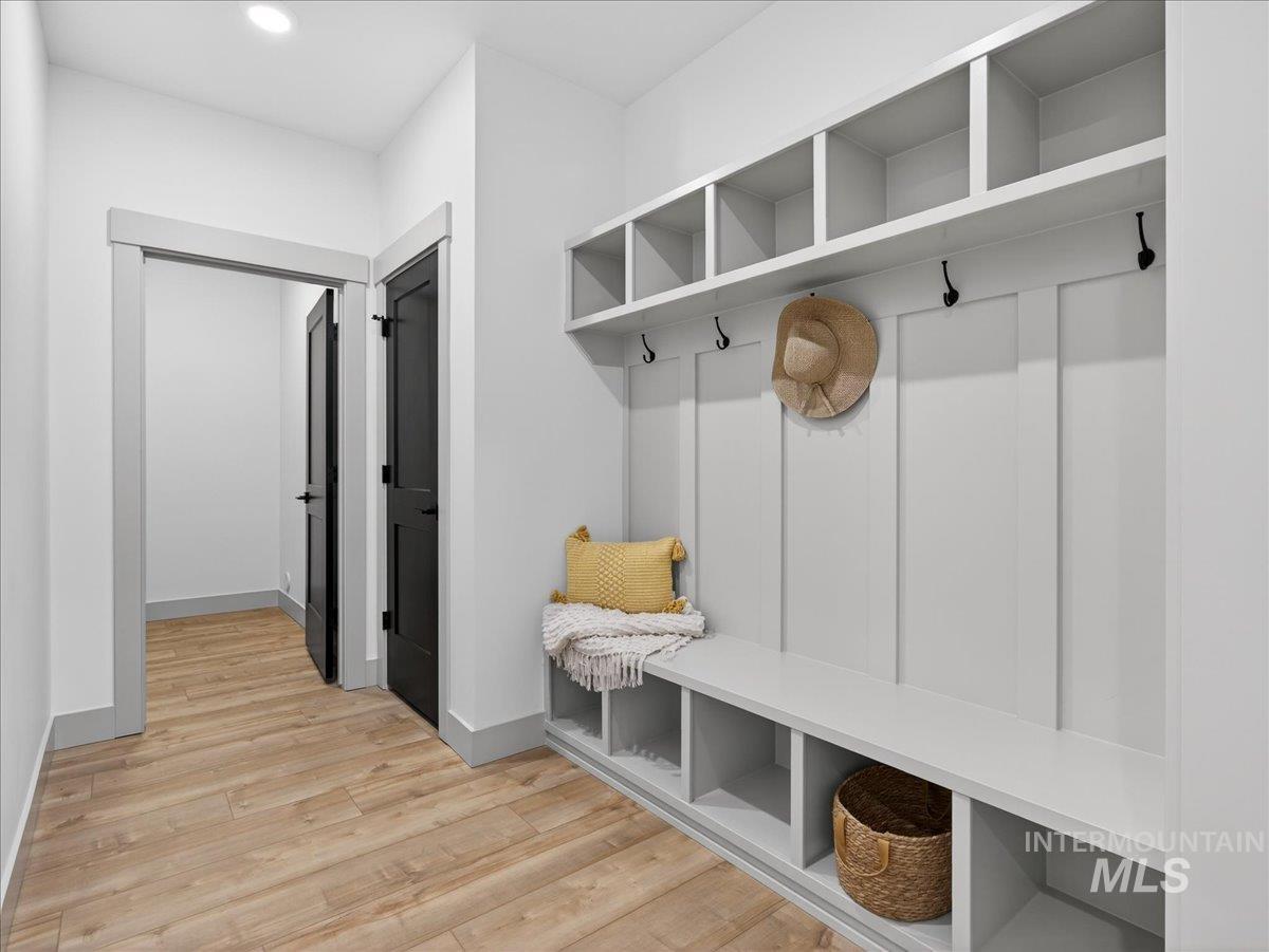 Mudroom with light wood-type flooring and recessed lighting