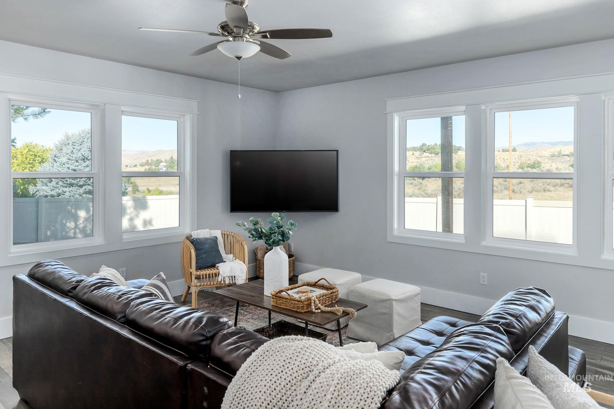 Living room featuring wood finished floors and ceiling fan