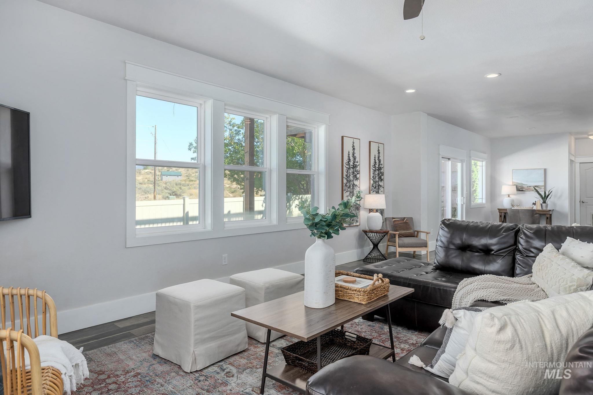 Living room with recessed lighting, wood finished floors, and ceiling fan