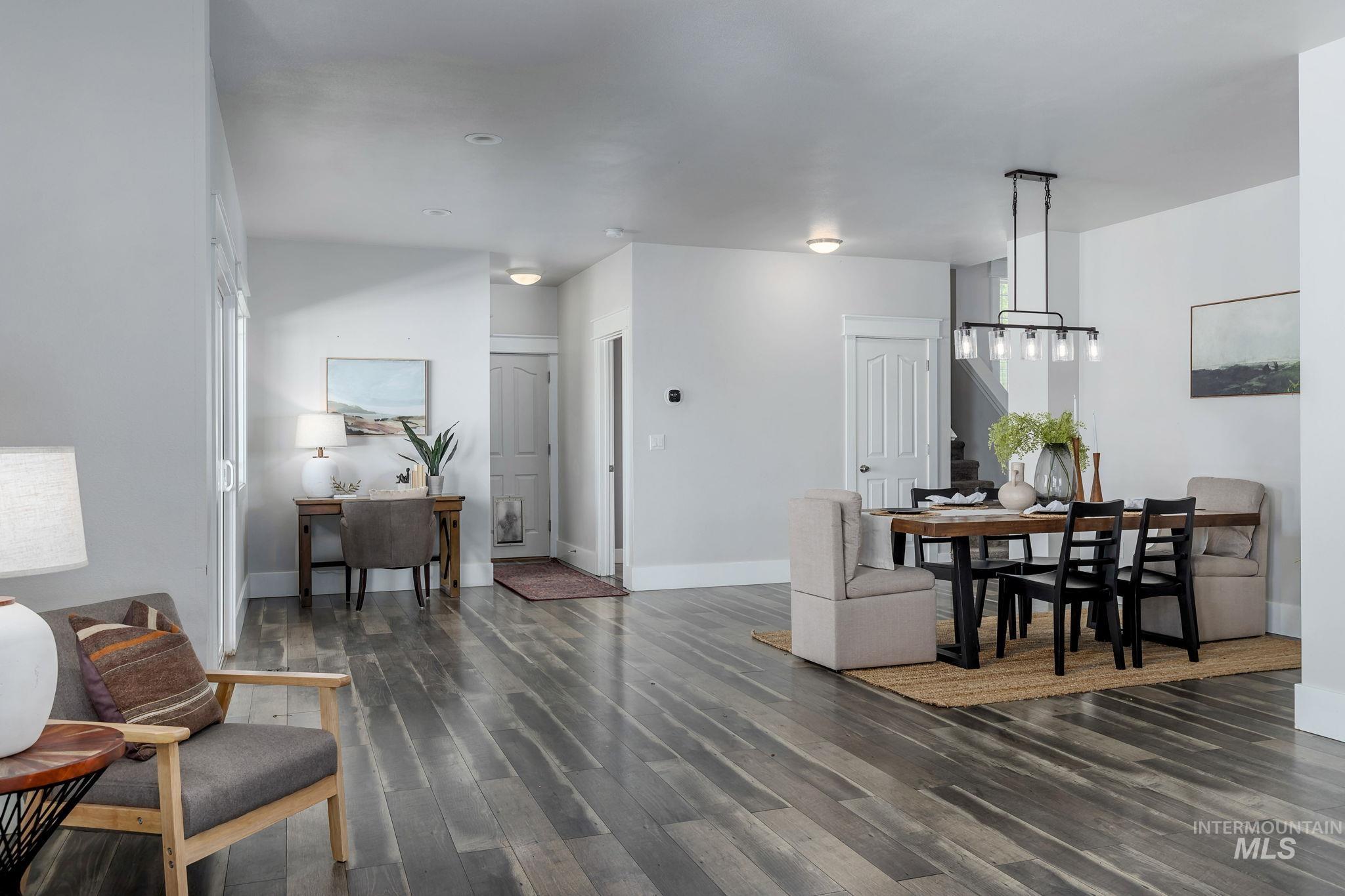 Dining space featuring dark wood-type flooring and baseboards