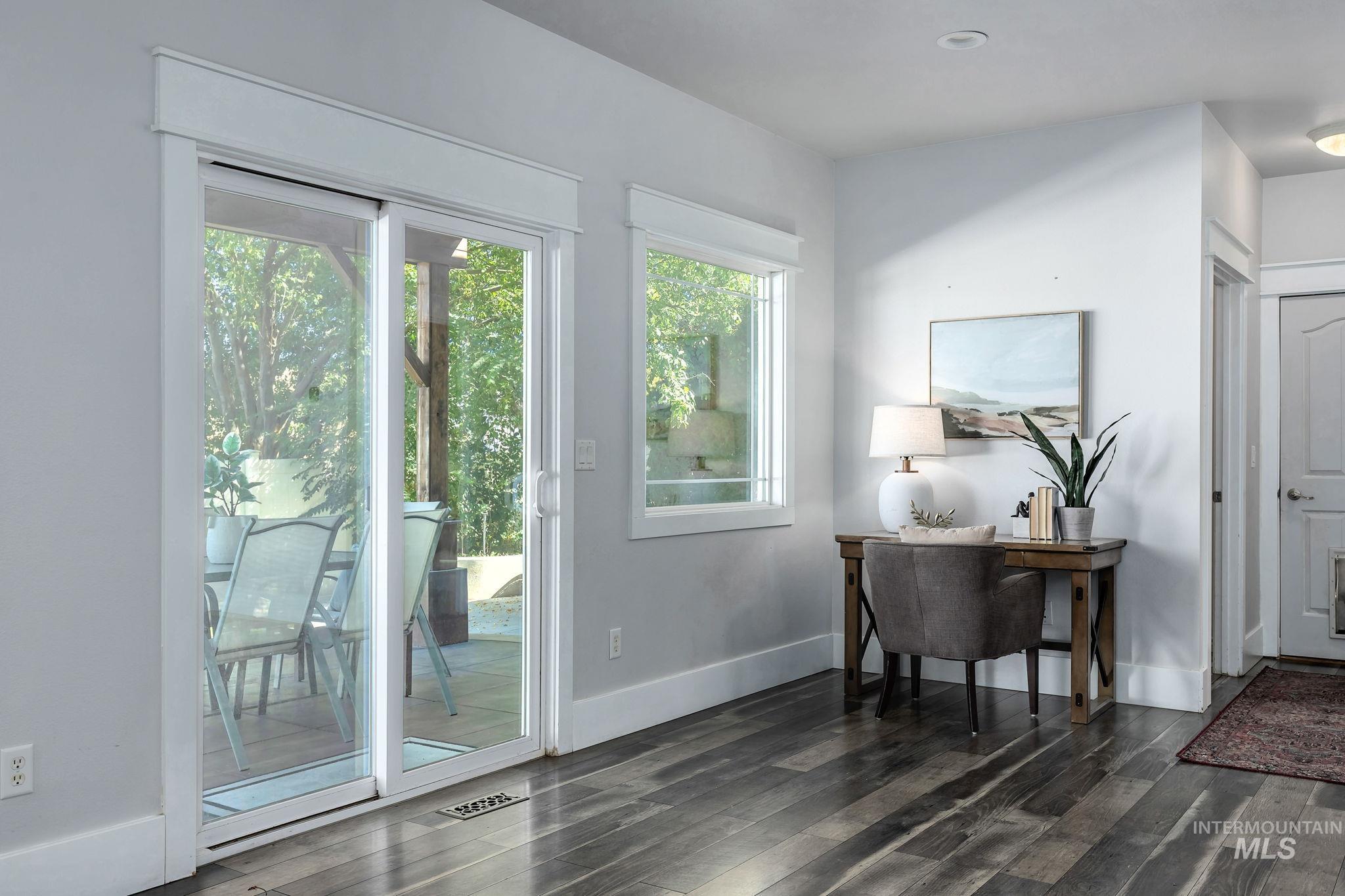 Doorway to outside with wood finished floors and recessed lighting