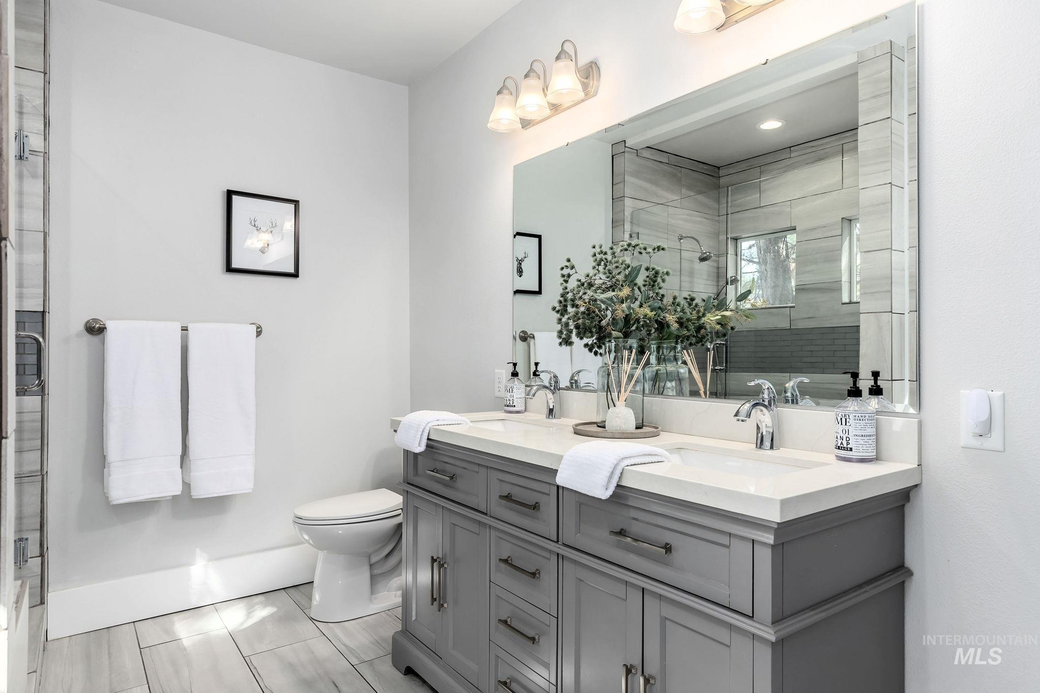 Bathroom with double vanity and a stall shower