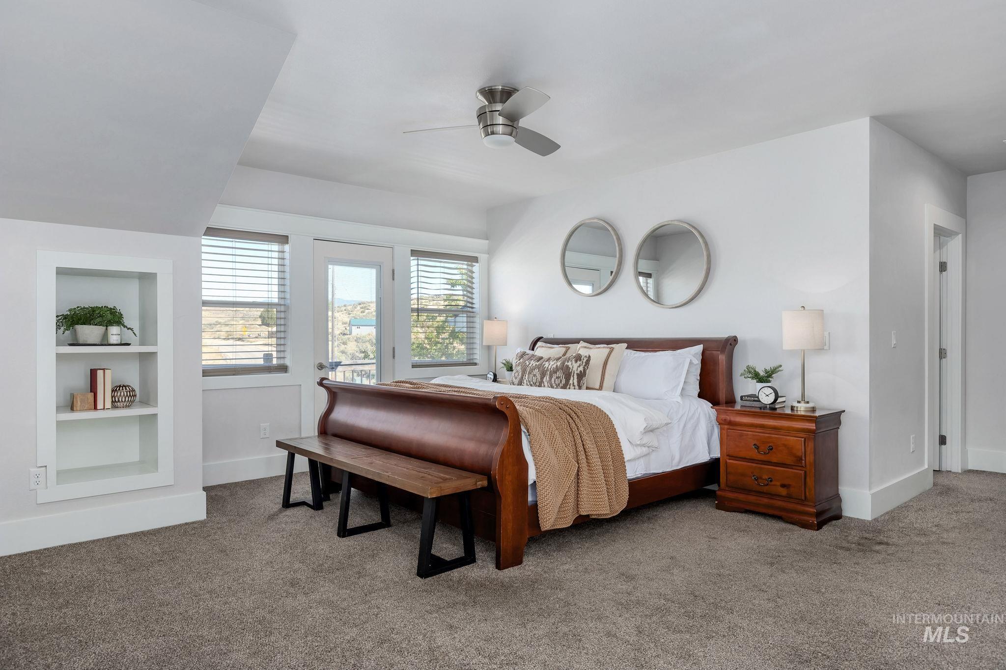 Bedroom with light colored carpet and a ceiling fan