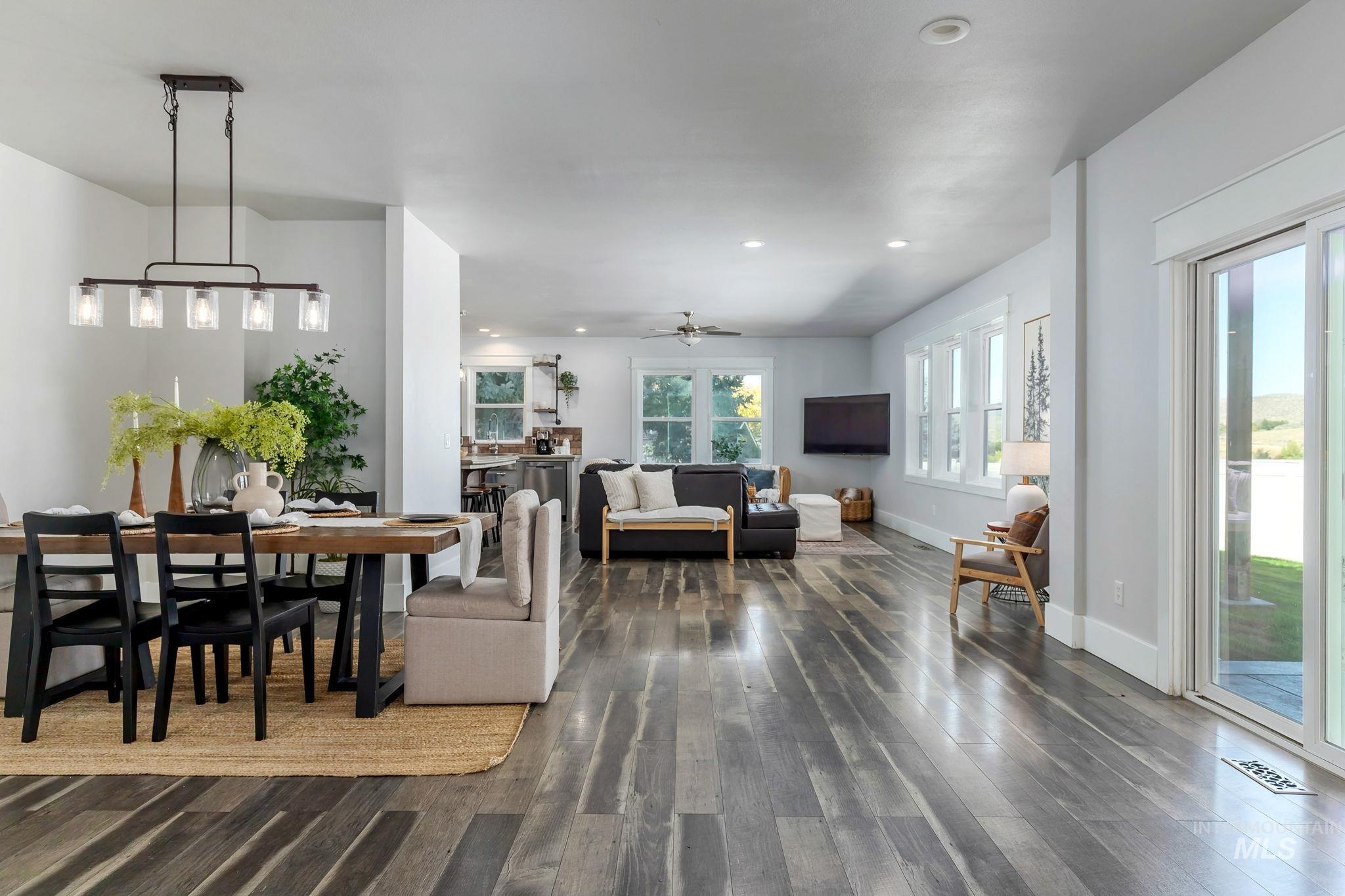 Dining space with ceiling fan, dark wood-type flooring, and recessed lighting