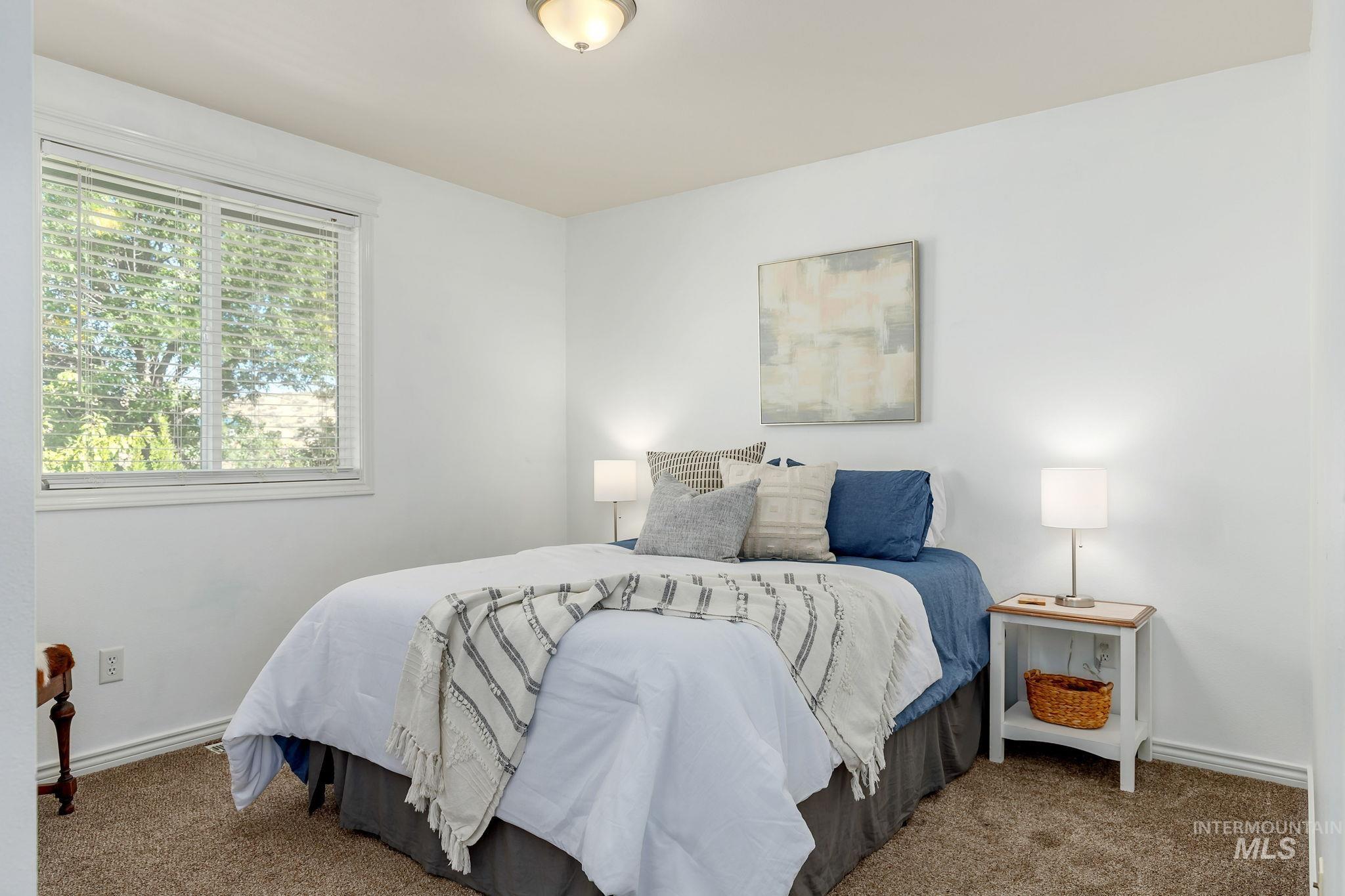 Carpeted bedroom featuring baseboards