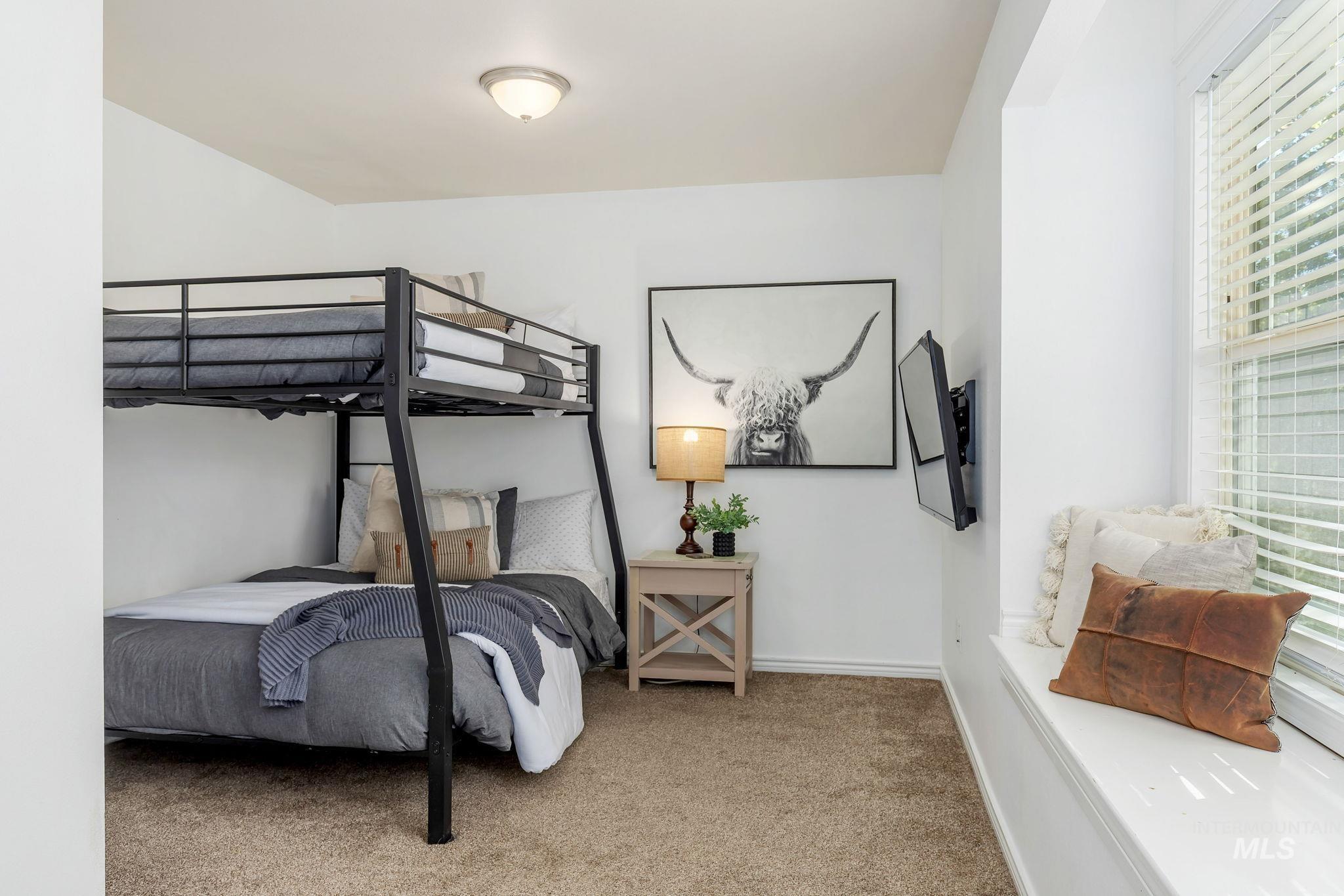 Carpeted bedroom featuring baseboards