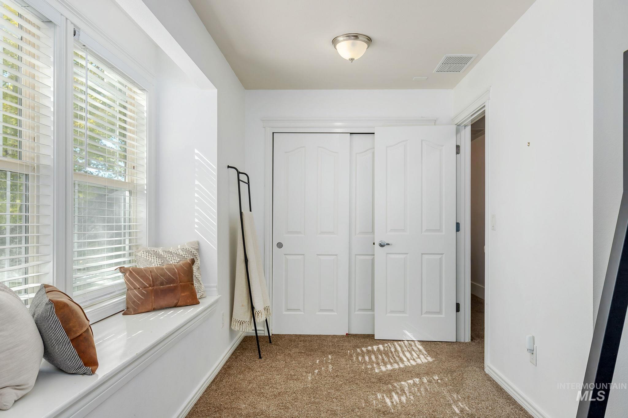 Interior space with carpet flooring and a closet