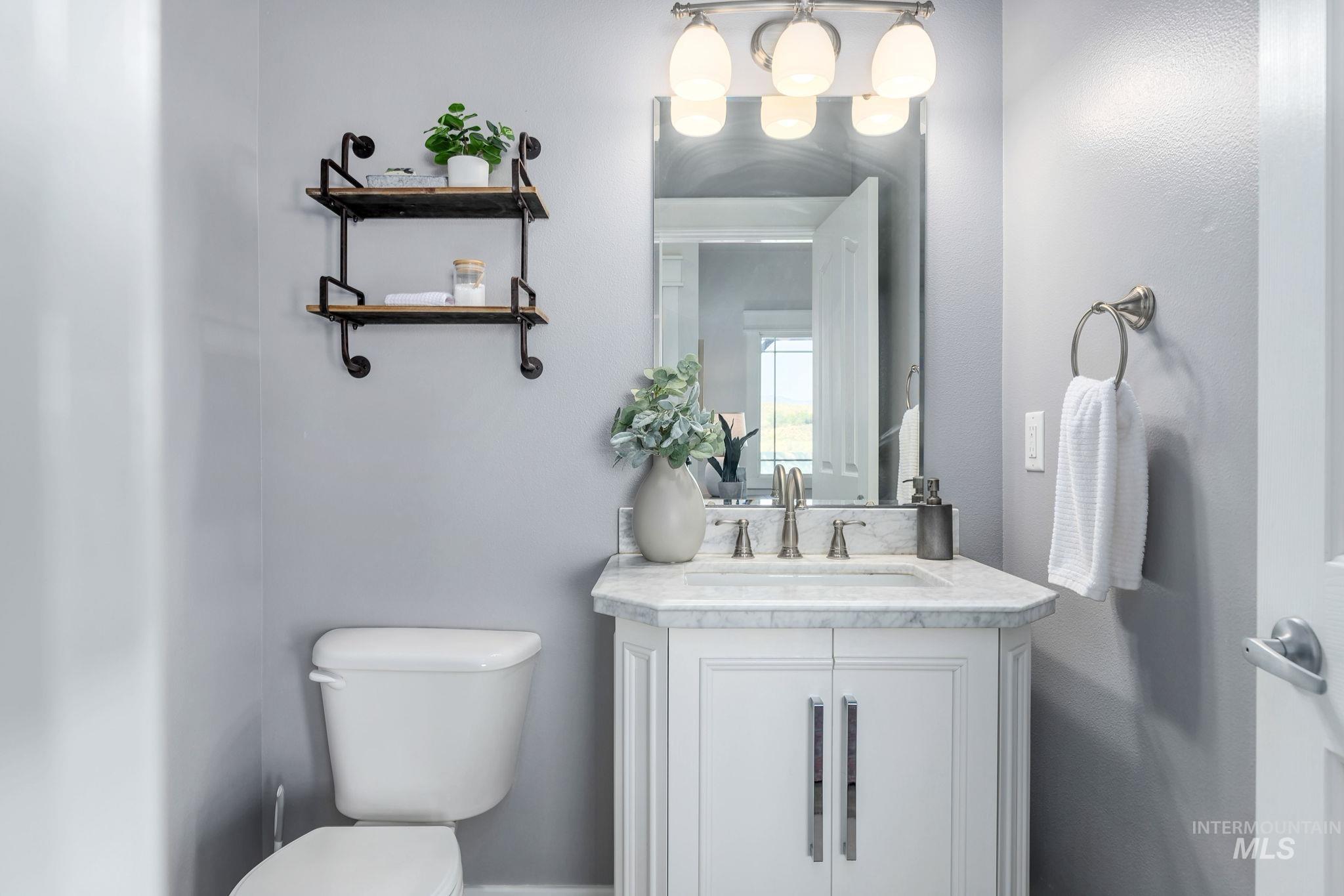 Half bathroom with vanity and toilet