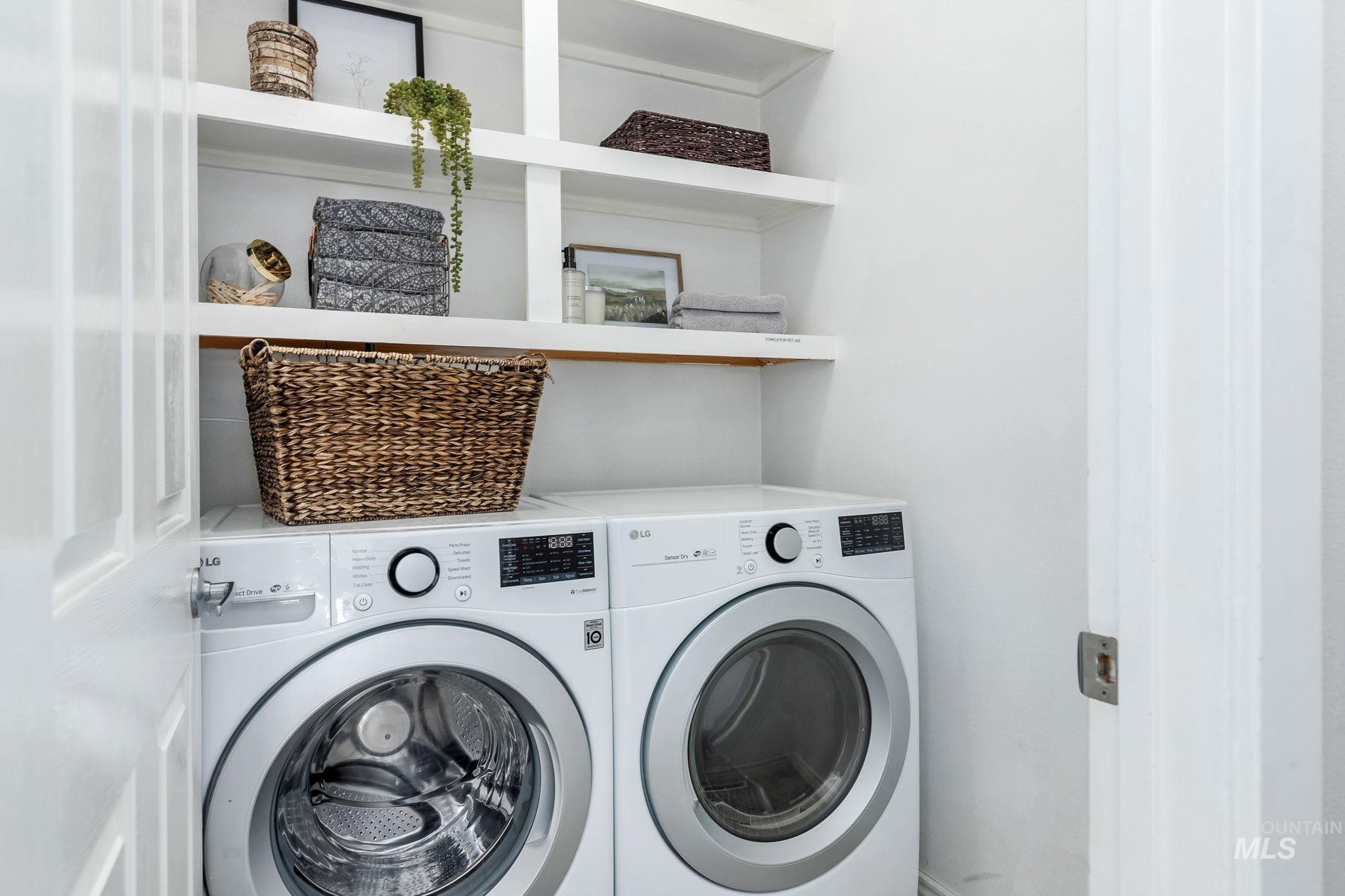 Washroom with washing machine and clothes dryer
