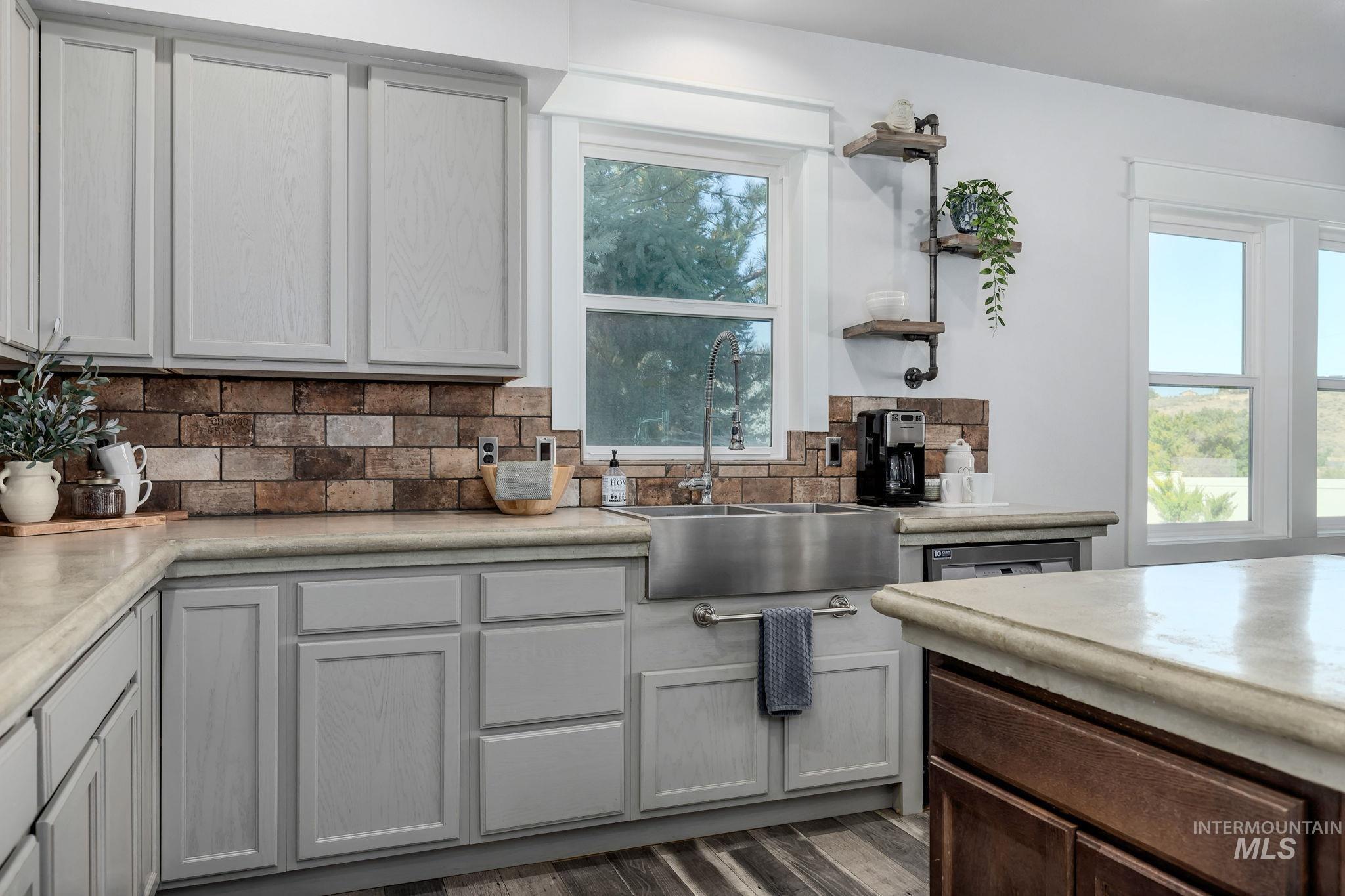 Kitchen featuring tasteful backsplash, open shelves, dark brown cabinets, dark wood-type flooring, and gray cabinetry