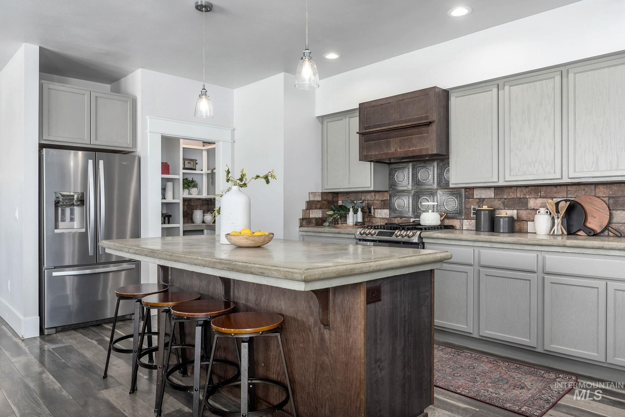 Kitchen featuring stainless steel appliances, gray cabinetry, dark wood-style flooring, backsplash, and recessed lighting