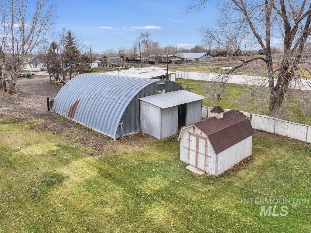 View of pole building featuring a storage shed and a residential view